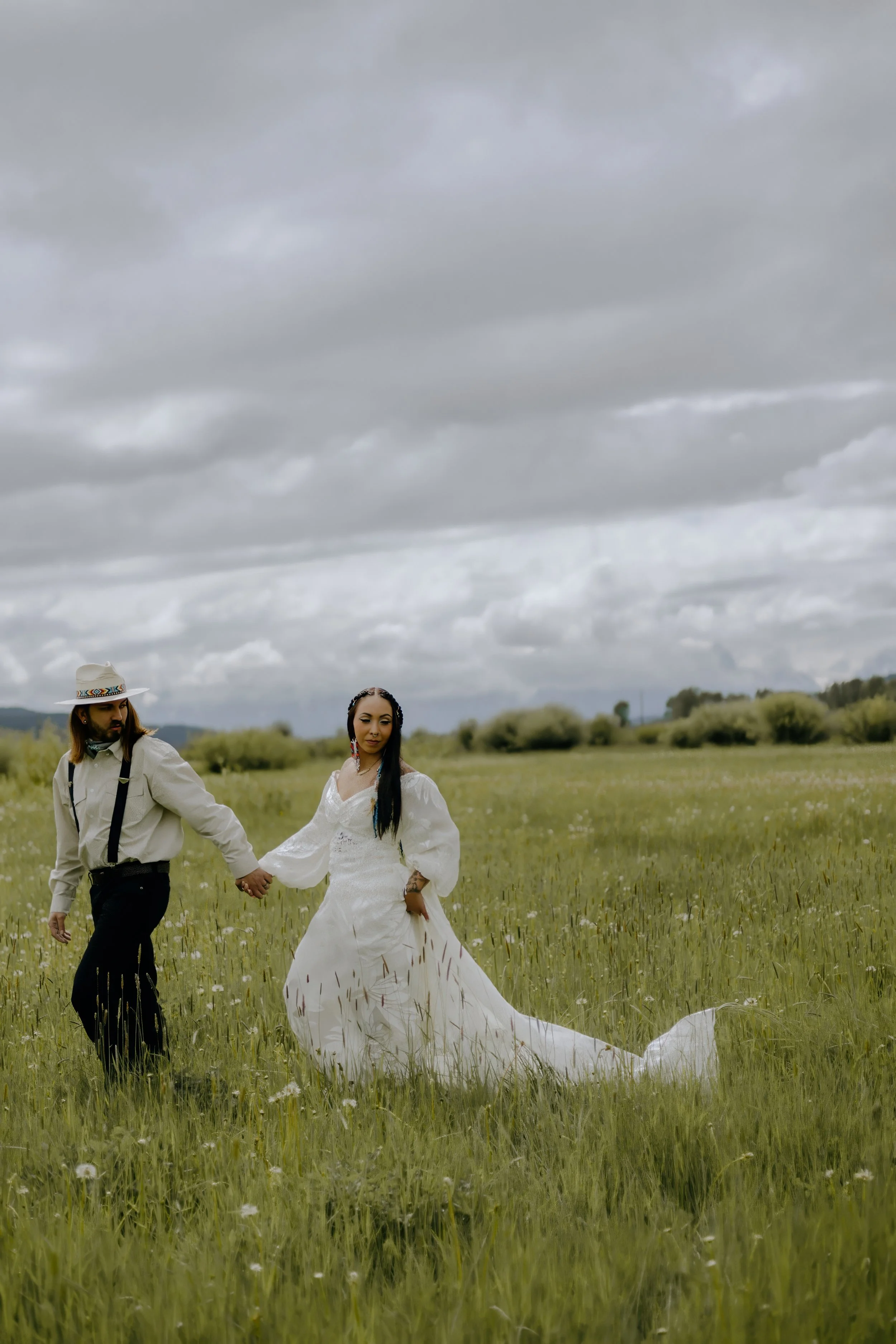 Houston & Texas Wedding & Elopement Photography – Couple holding hands and walking away in meadow at Diamond Cross Ranch, Wyoming.
