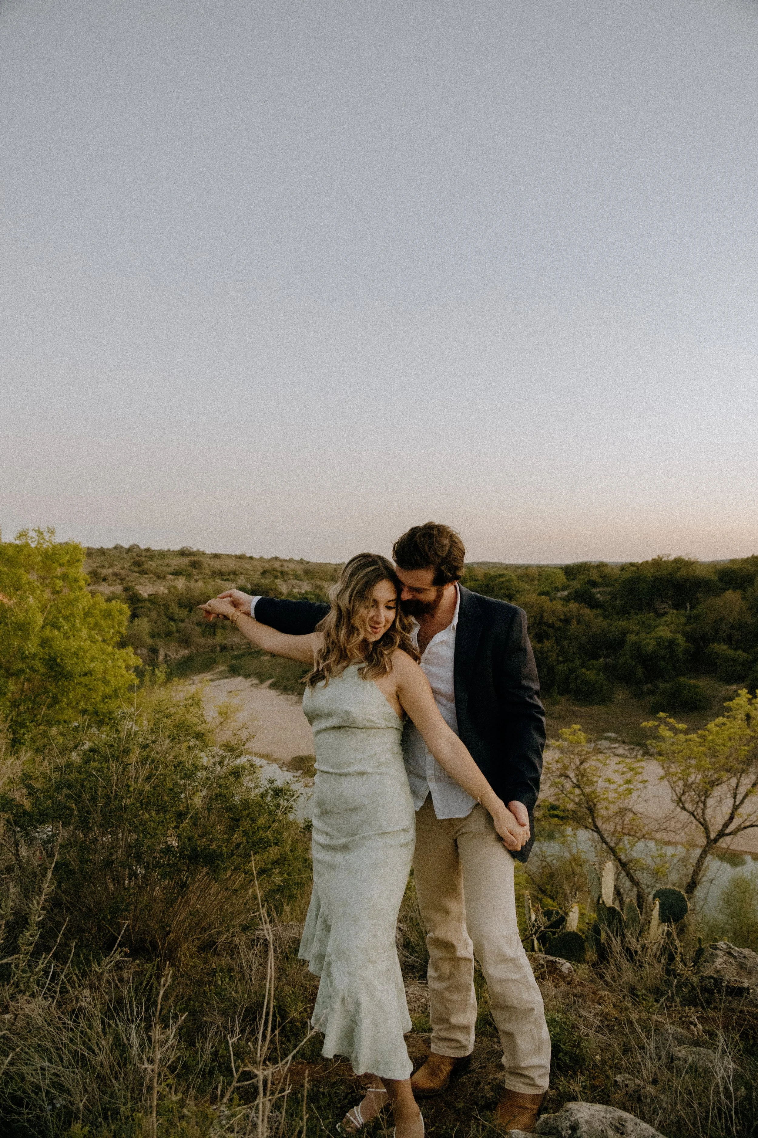 Houston & Texas Family, Couples, Newborn, Maternity, Bridal Photography – Candid couple dancing together in Austin TX meadow at sunset.