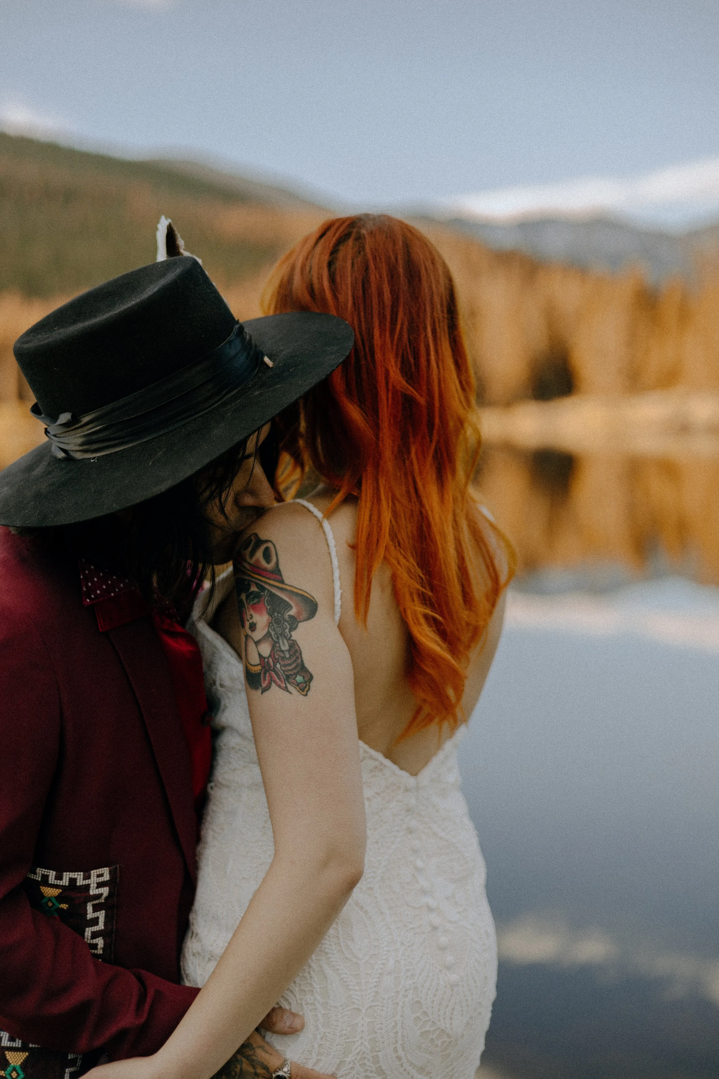 Houston & Texas Wedding & Elopement Photography – Bride leaning on groom by golden lake shore at Echo Lake Colorado elopement.