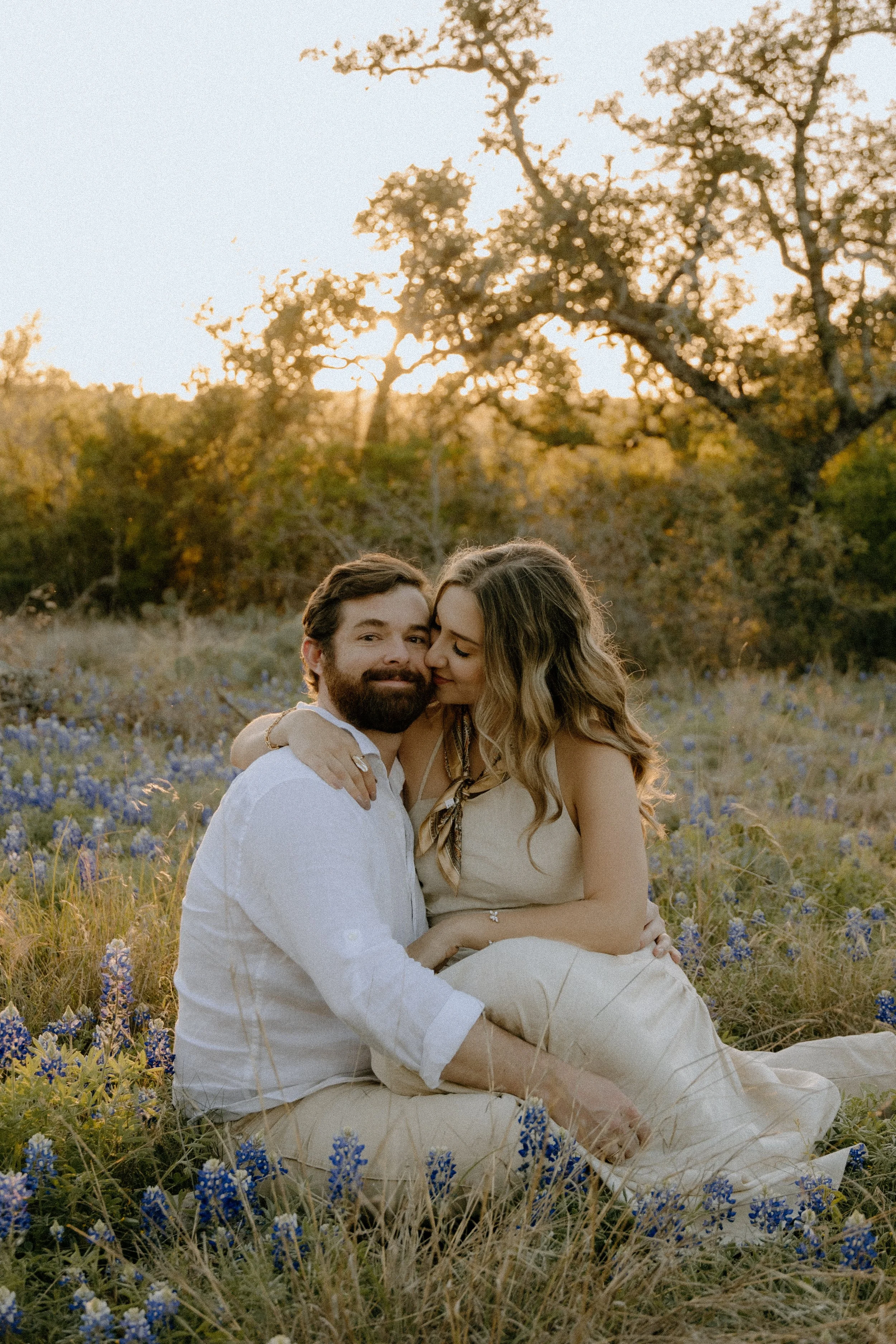 Houston & Texas Family, Couples, Newborn, Maternity, Bridal Photography – Candid couple portrait seated in Austin TX wildflower meadow.