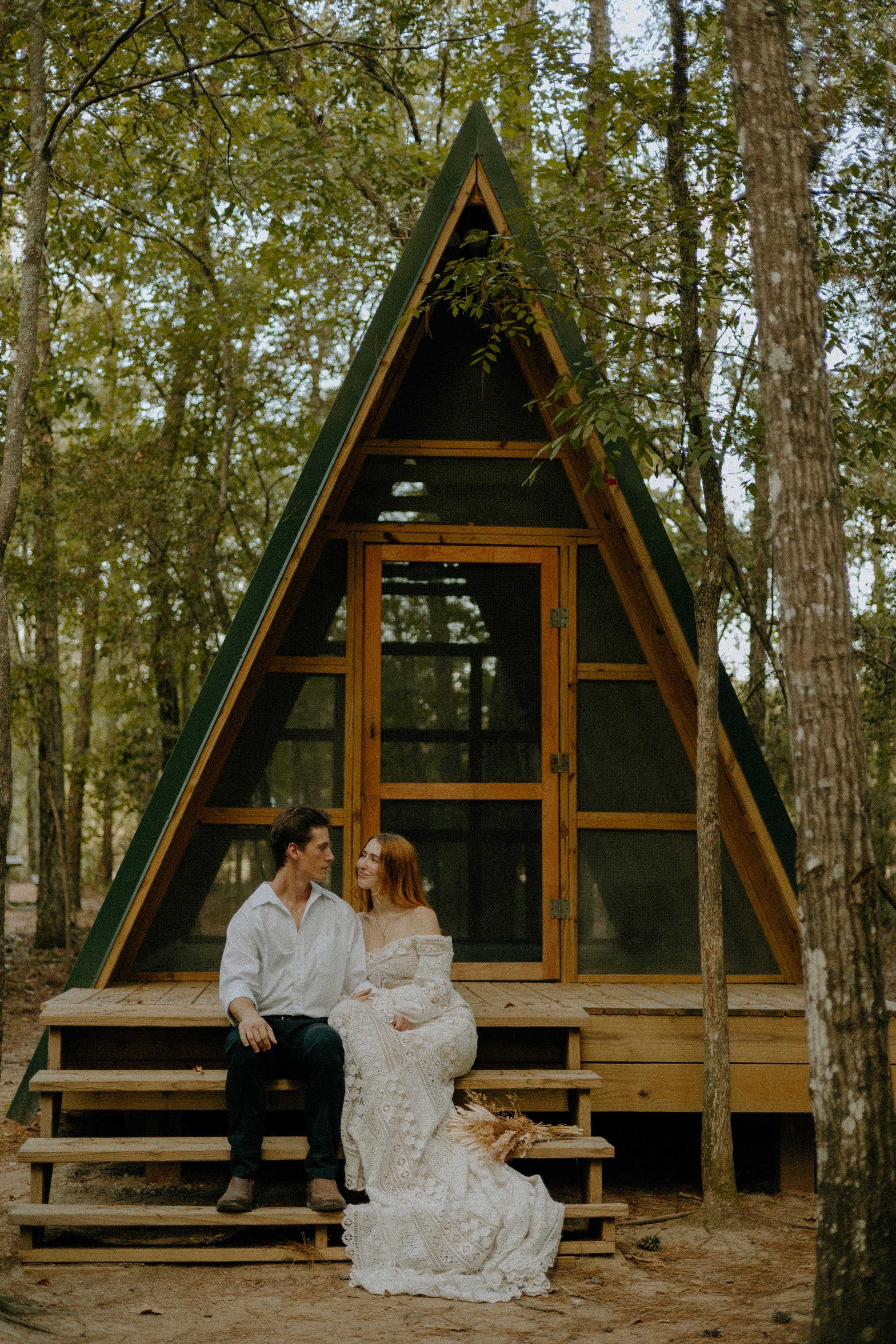 Wedding & Elopement Photography, Couple sharing a romantic moment in front of a wooden cabin at Lake Houston