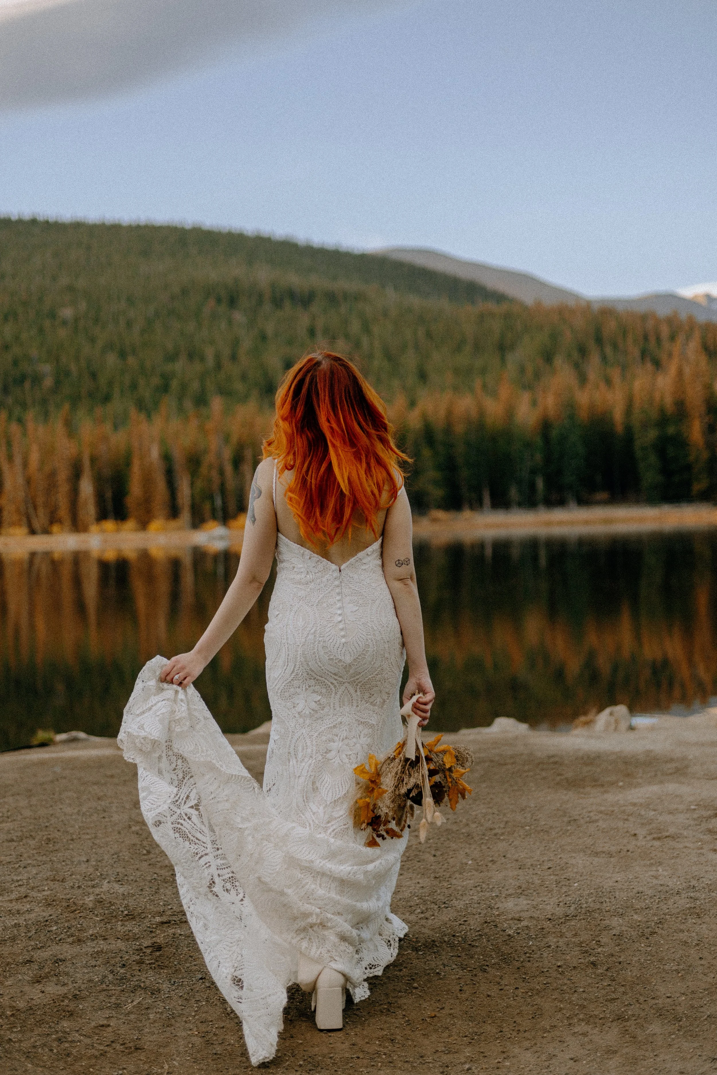 Houston & Texas Wedding & Elopement Photography – Bride walking away with bouquet in hand by Echo Lake Colorado.