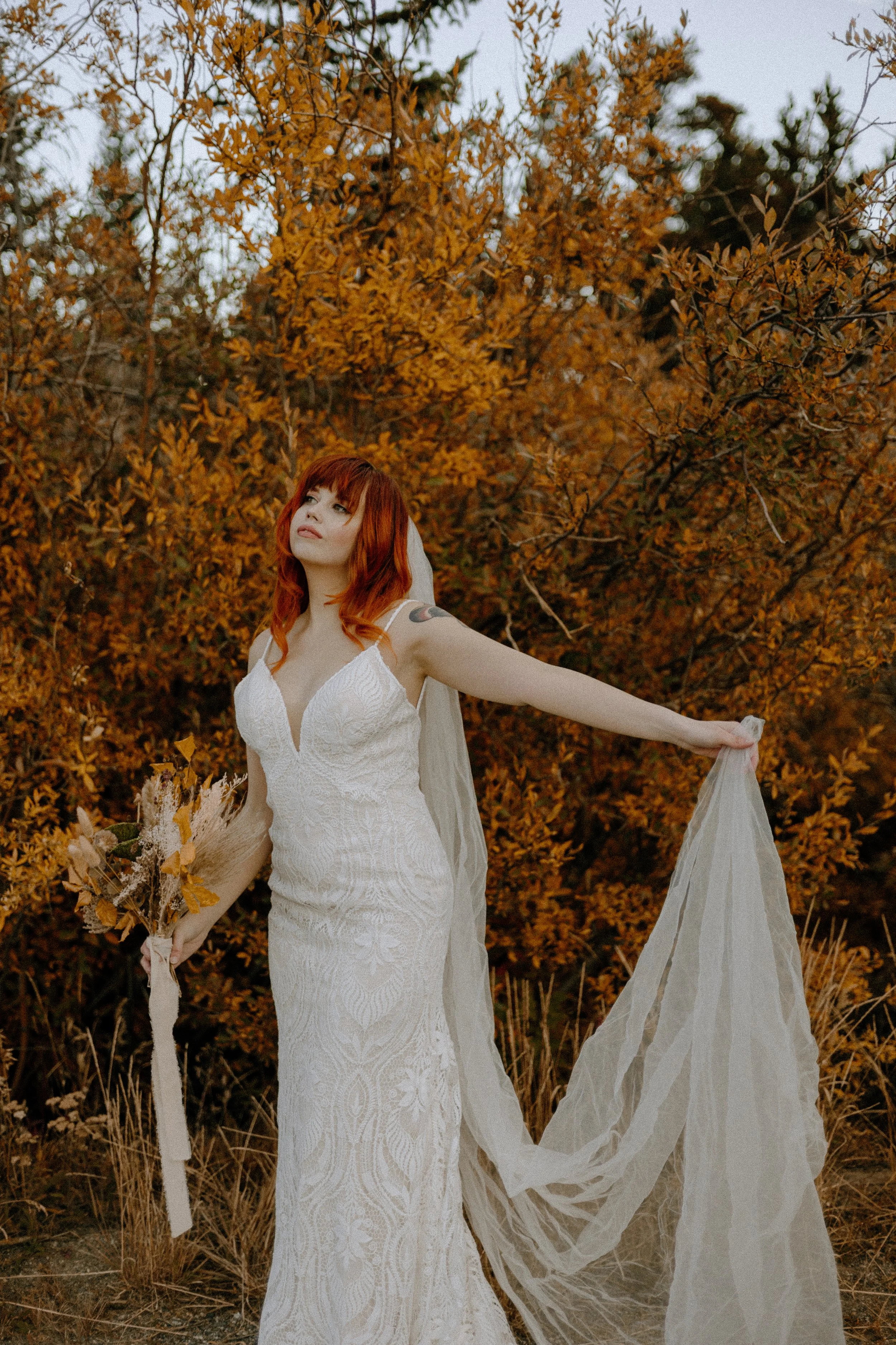Houston & Texas Wedding & Elopement Photography – Bride spreading gown near golden foliage at Echo Lake Colorado.