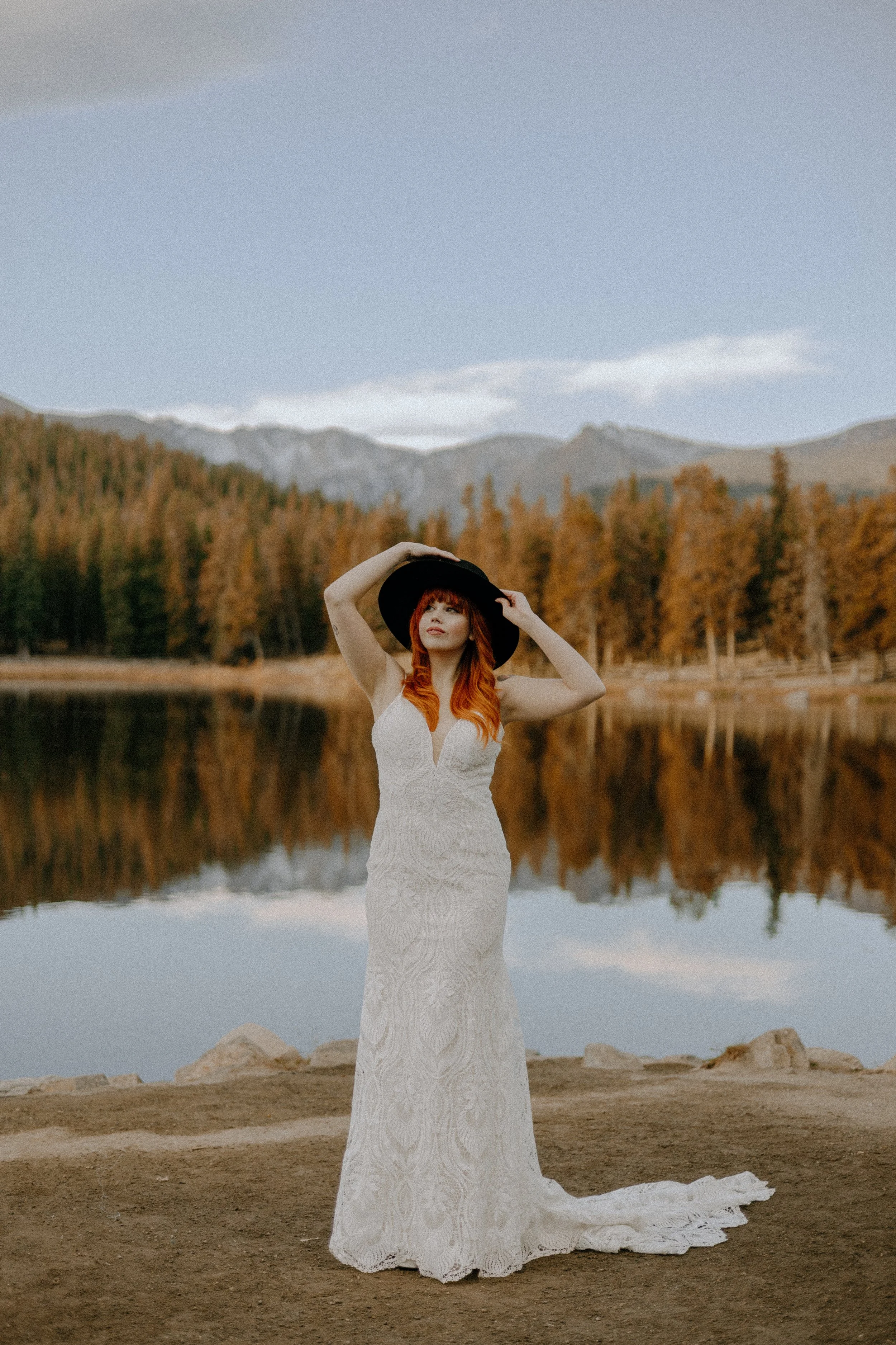 Houston & Texas Wedding & Elopement Photography – Bride walking along Echo Lake shoreline with Colorado mountain reflections.