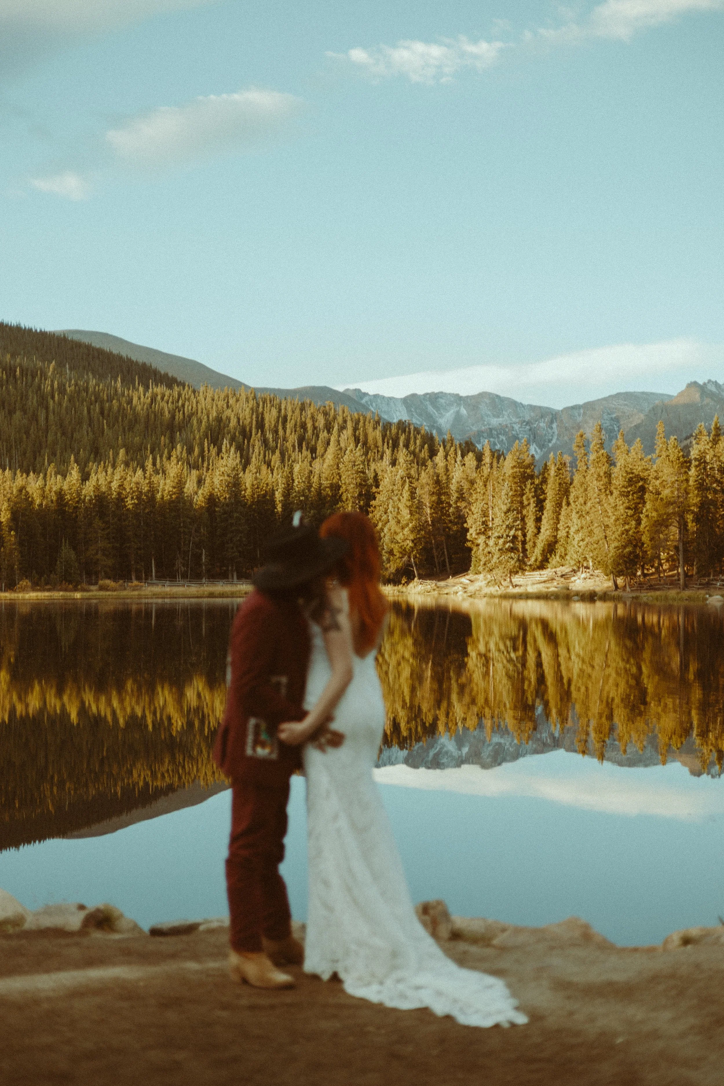 Houston & Texas Wedding & Elopement Photography – Groom looking at mountains by Echo Lake with golden autumn trees.