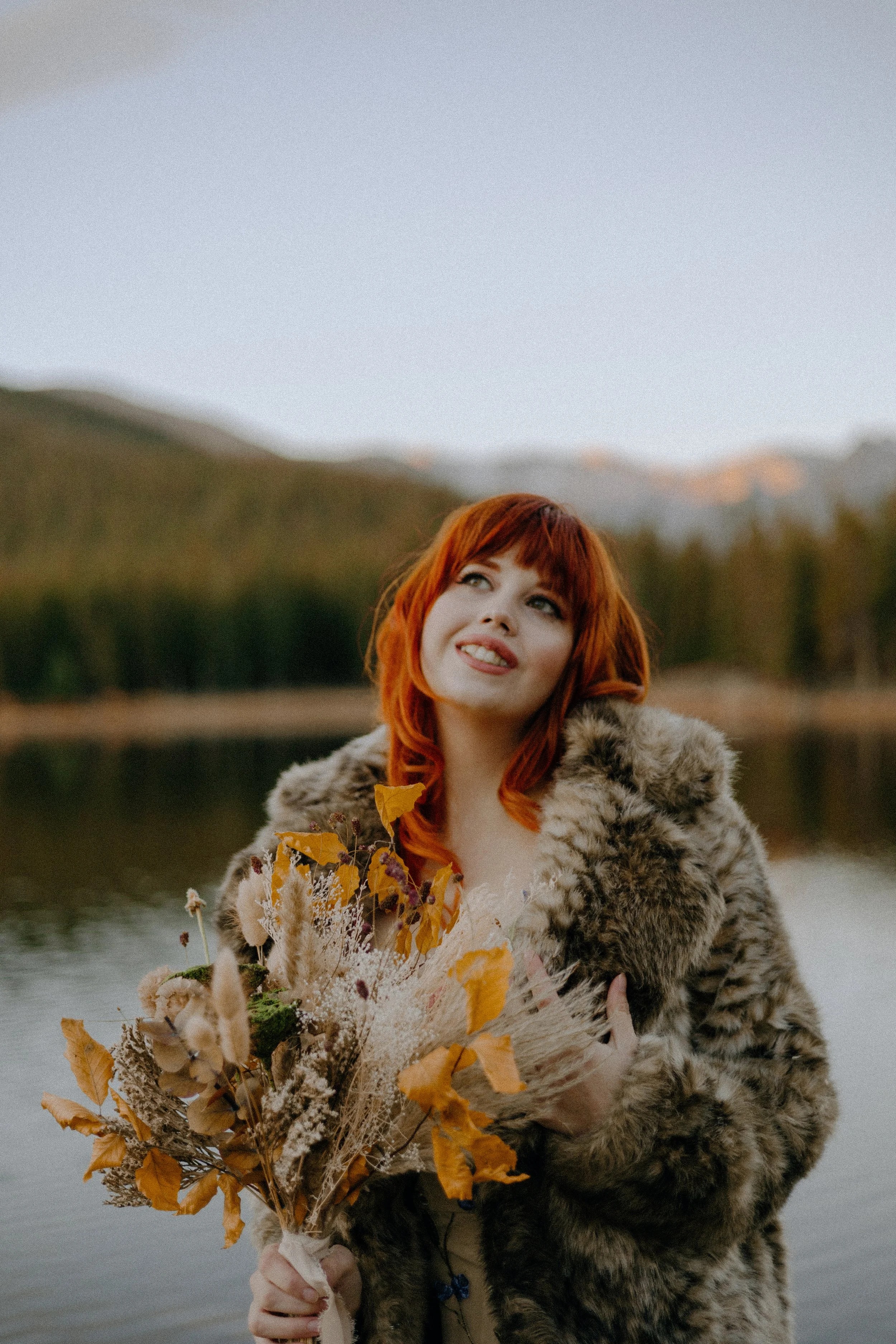 Houston & Texas Wedding & Elopement Photography – Bride in fur wrap gazing out at Echo Lake Colorado.