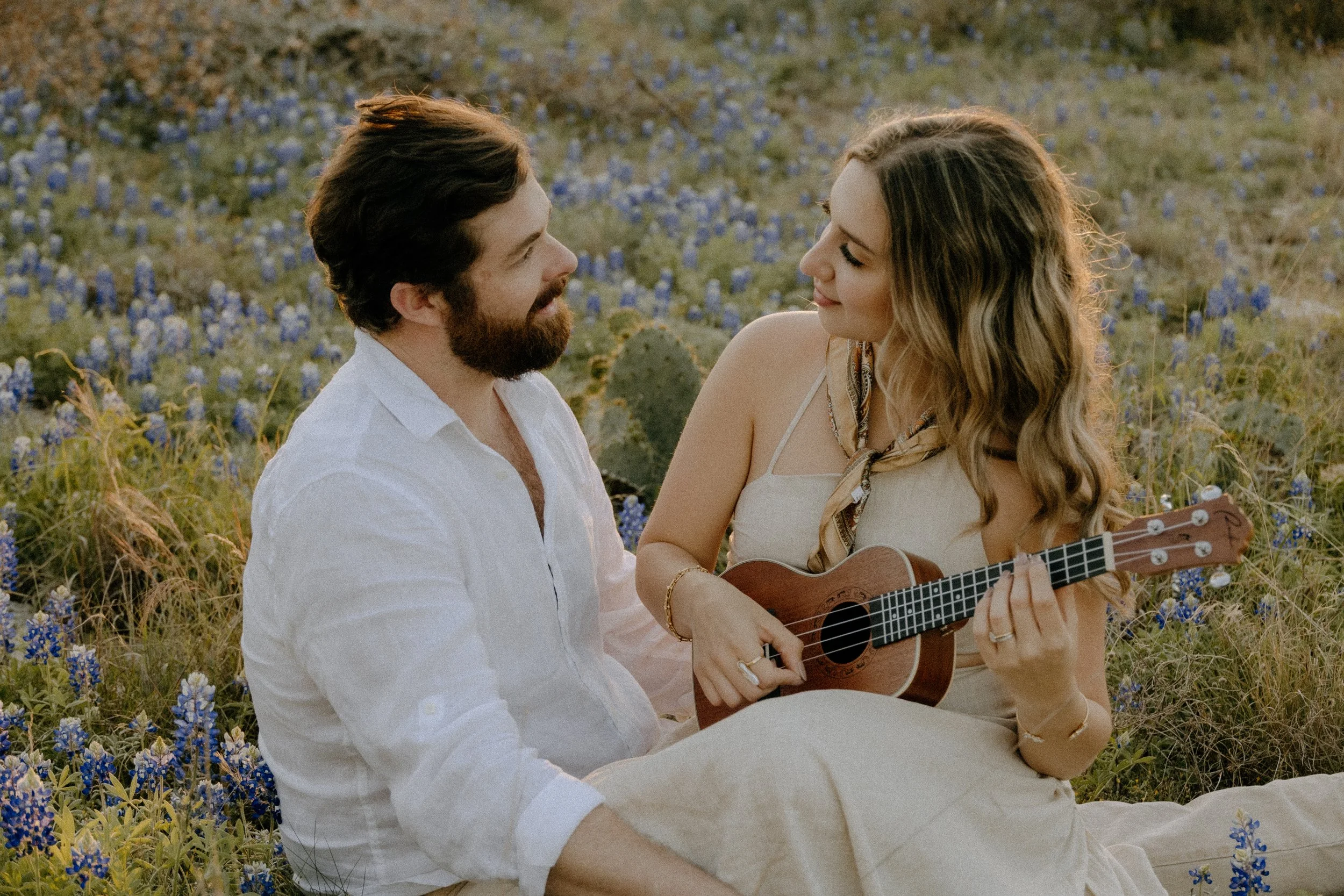 Houston & Texas Family, Couples, Newborn, Maternity, Bridal Photography – Couple strumming guitar in wildflower field, Austin TX.