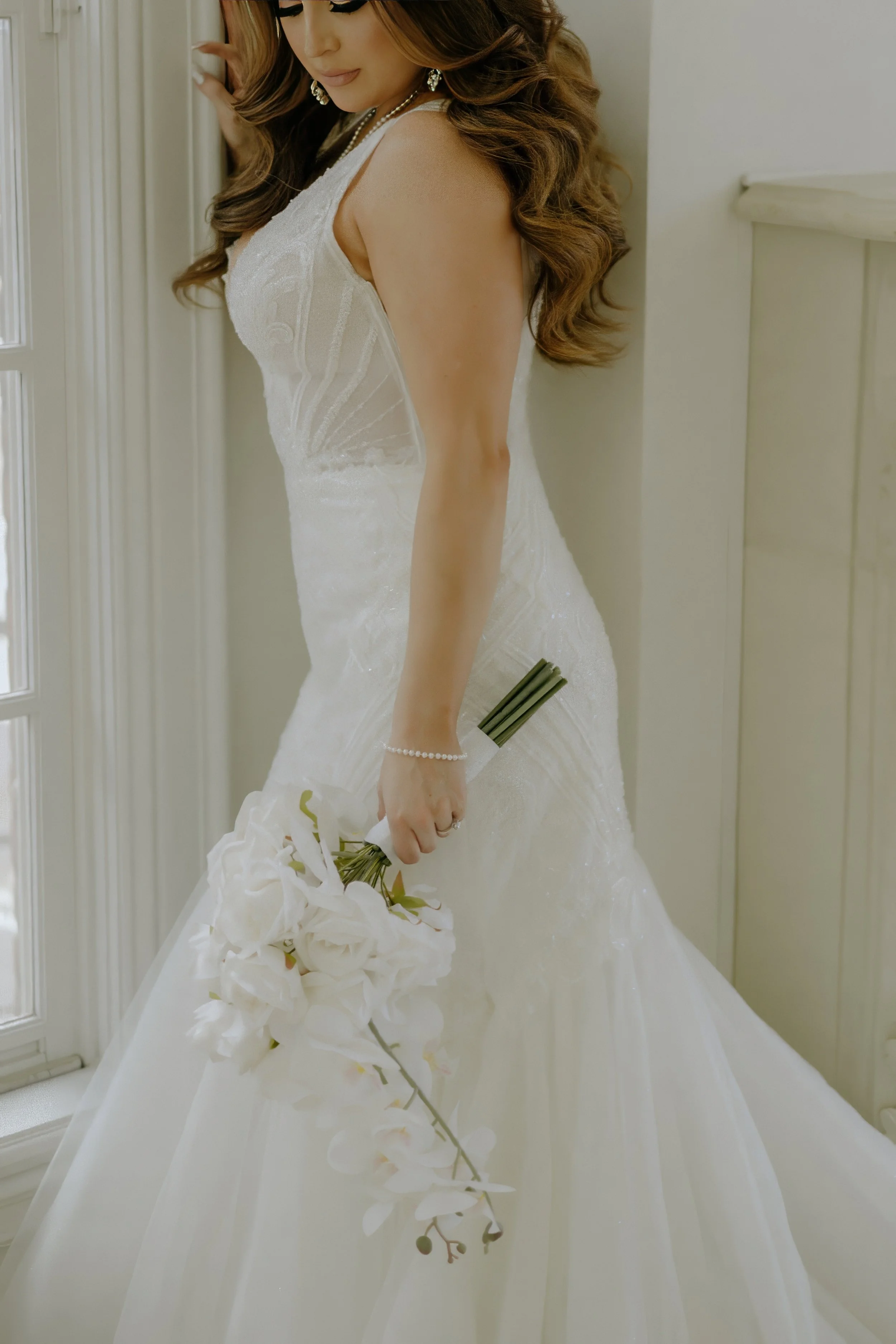 Houston & Texas Family, Couples, Newborn, Maternity, Bridal Photography – Detail of lace gown and bouquet against white-and-gold Houston studio.