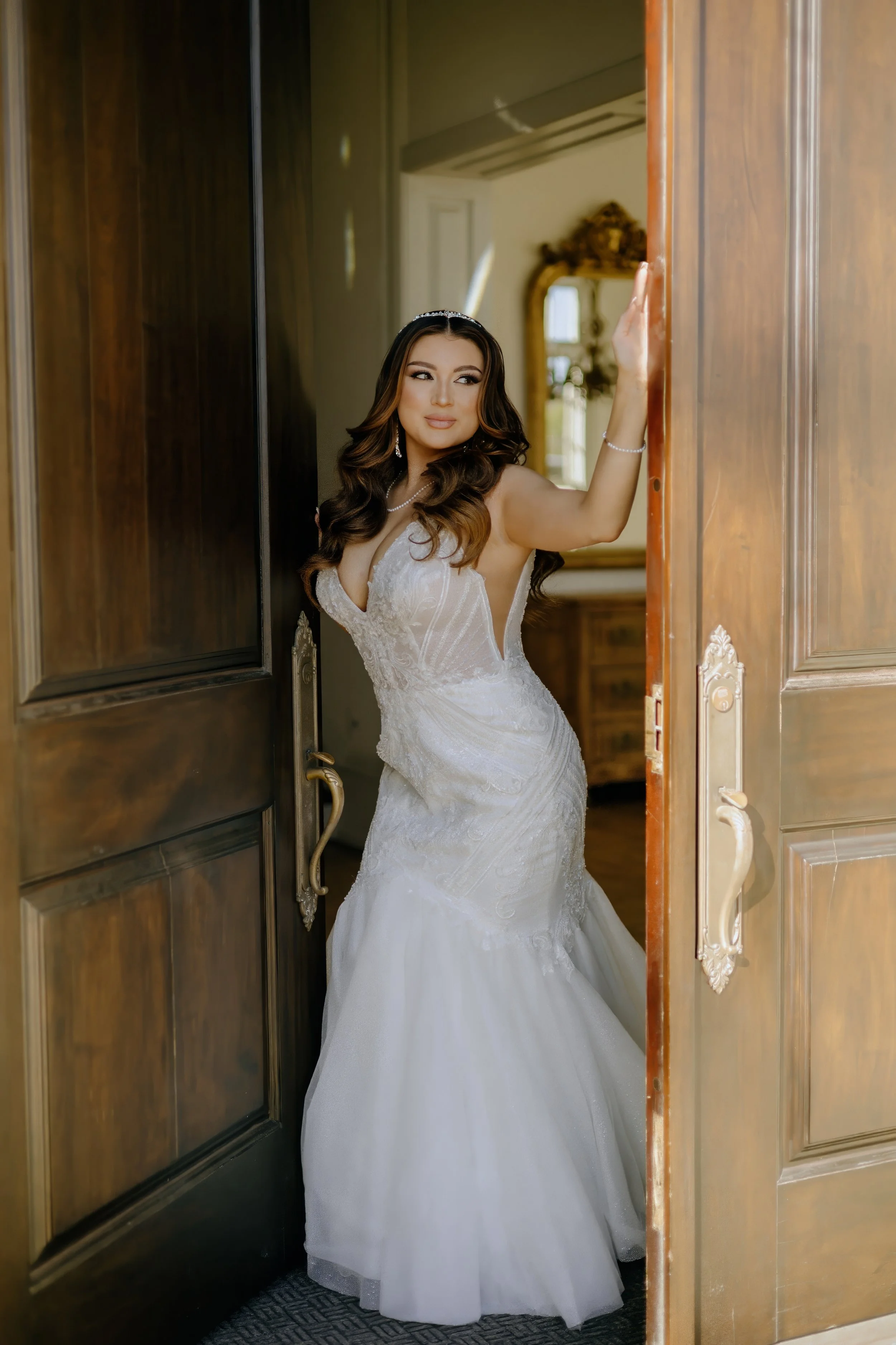 Houston & Texas Family, Couples, Newborn, Maternity, Bridal Photography – Bride framed by ornate wooden doors at upscale Houston white-and-gold studio.