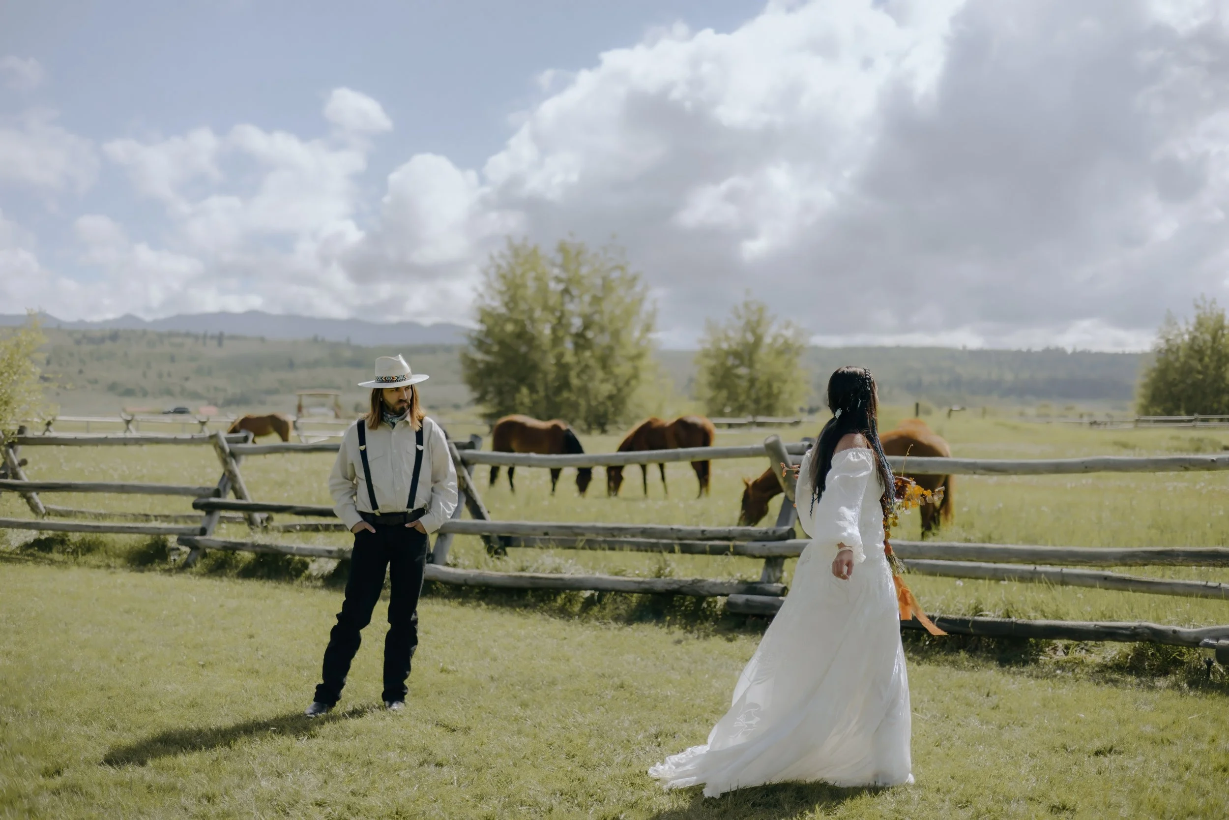 Houston & Texas Wedding & Elopement Photography – Groom gazing at bride in meadow framed by mountains at Diamond Cross Ranch.