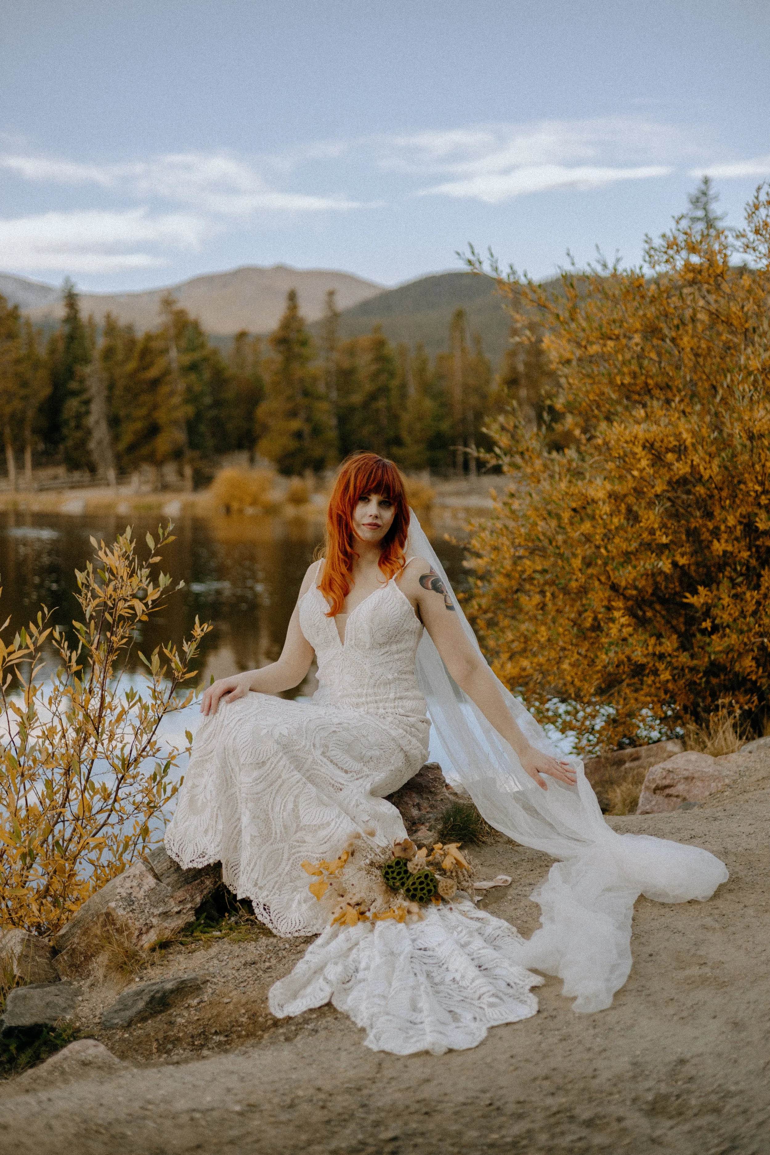 Houston & Texas Wedding & Elopement Photography – Bride looking up while seated in white gown at Echo Lake Colorado.