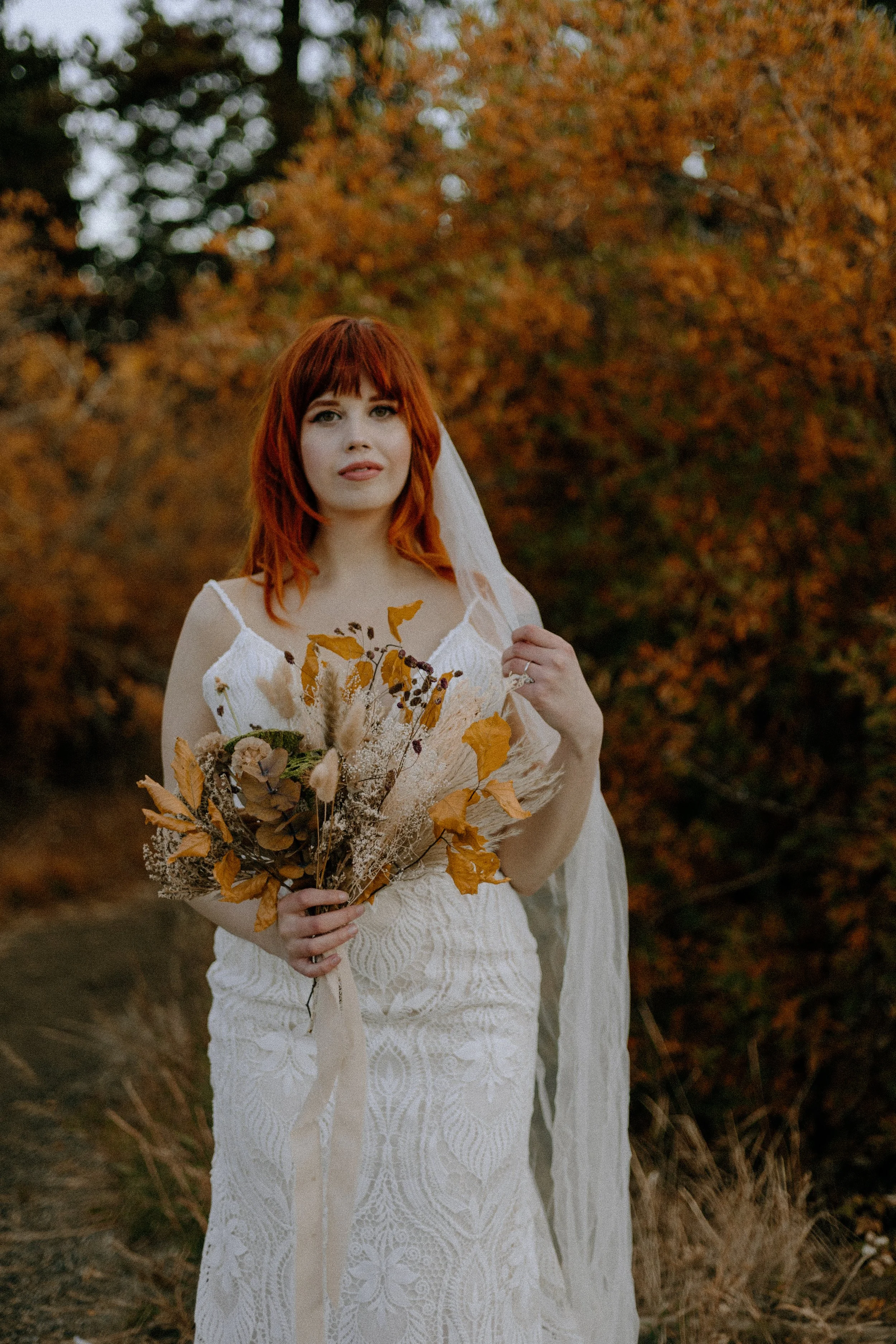 Houston & Texas Wedding & Elopement Photography – Bride holding veil in fall forest at Echo Lake Colorado elopement.