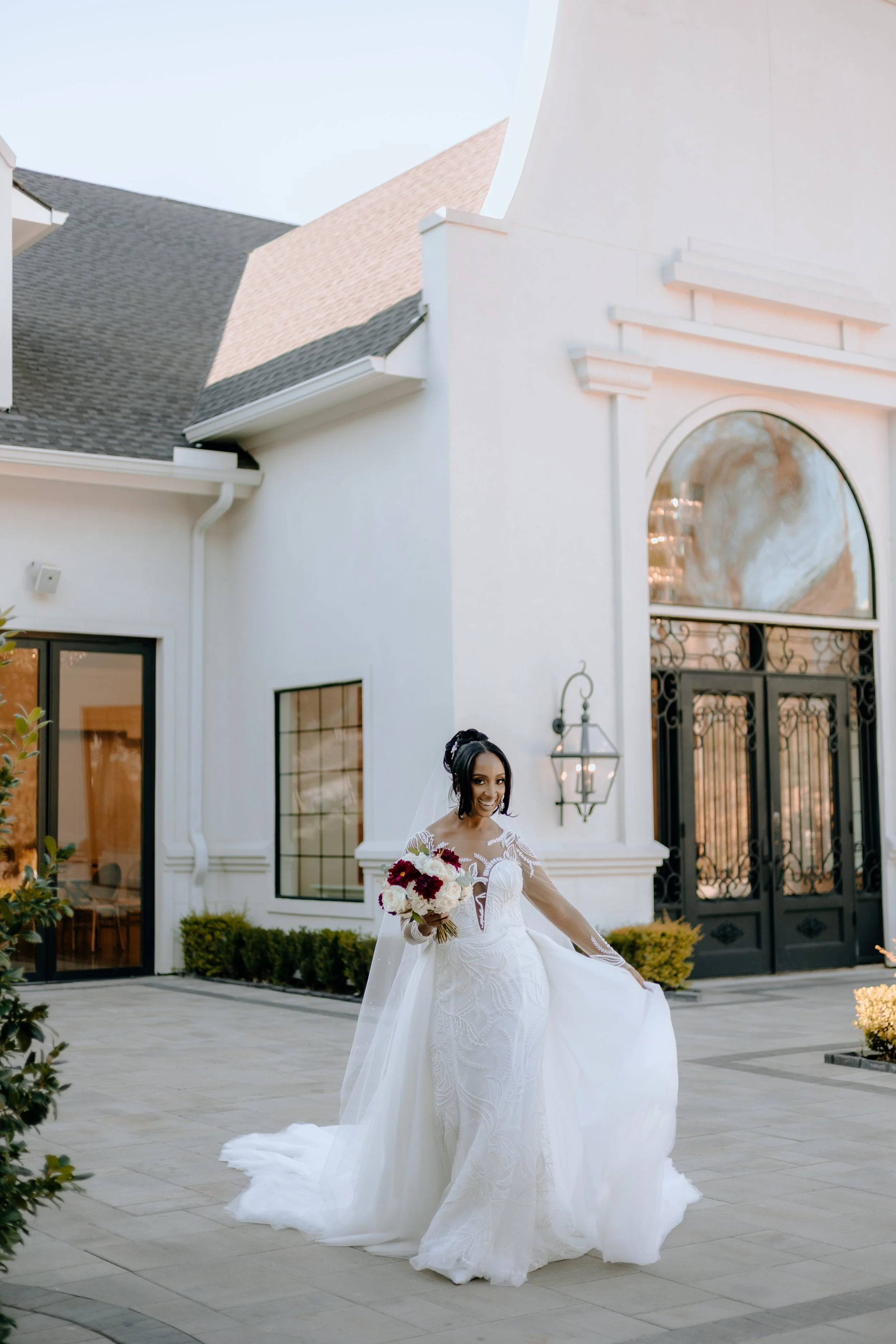 Houston & Texas Family, Couples, Newborn, Maternity, Bridal Photography – Bride standing outside Peach Orchard Venue, veil flowing.