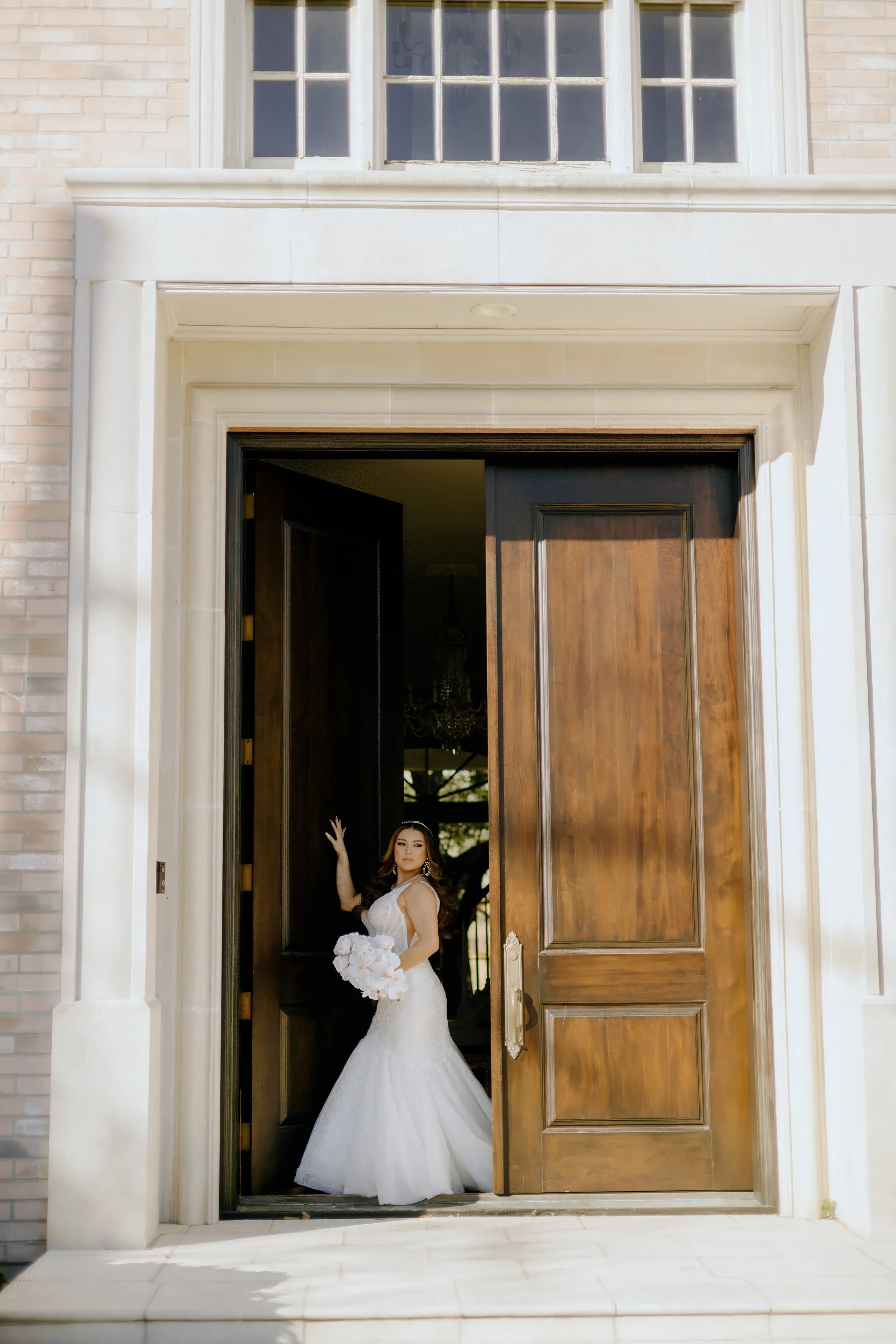 Houston & Texas Family, Couples, Newborn, Maternity, Bridal Photography – Bride stepping through grand wooden doorway at Houston studio.