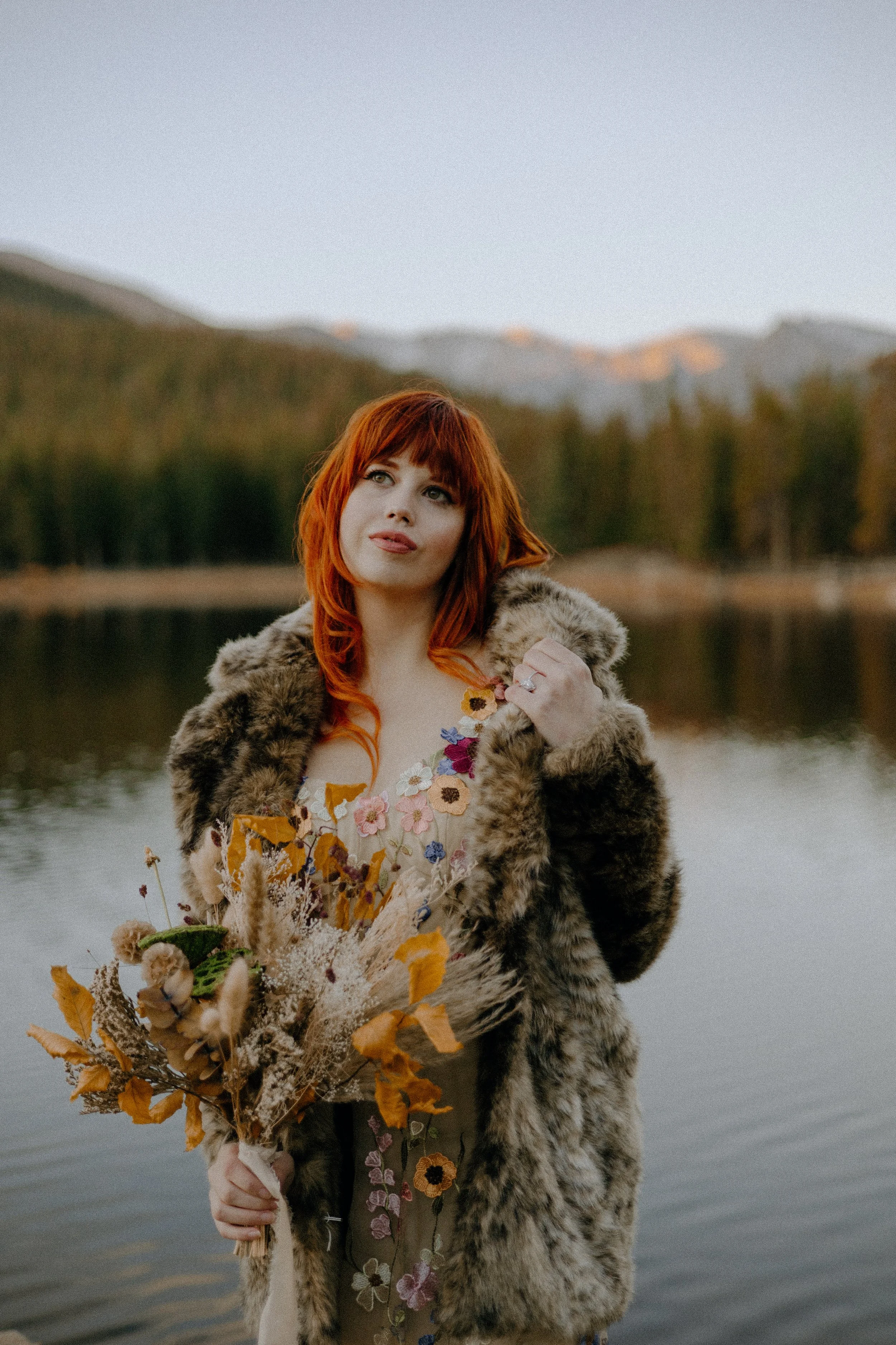 Houston & Texas Wedding & Elopement Photography – Bride lifting autumn bouquet near Echo Lake Colorado alpine lake.