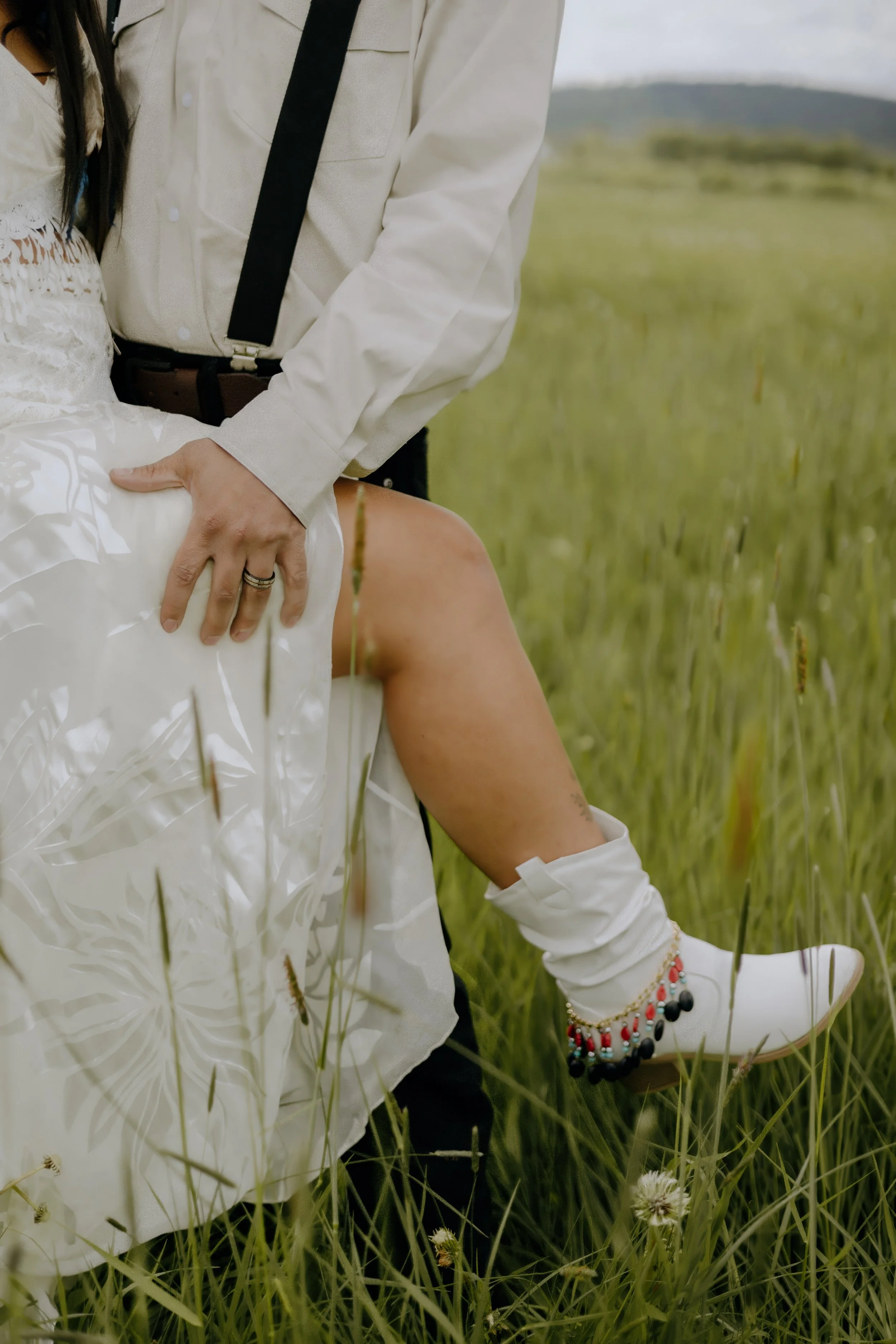 Houston & Texas Wedding & Elopement Photography – Close-up of bride’s leg and boots peeking from gown at Diamond Cross Ranch.