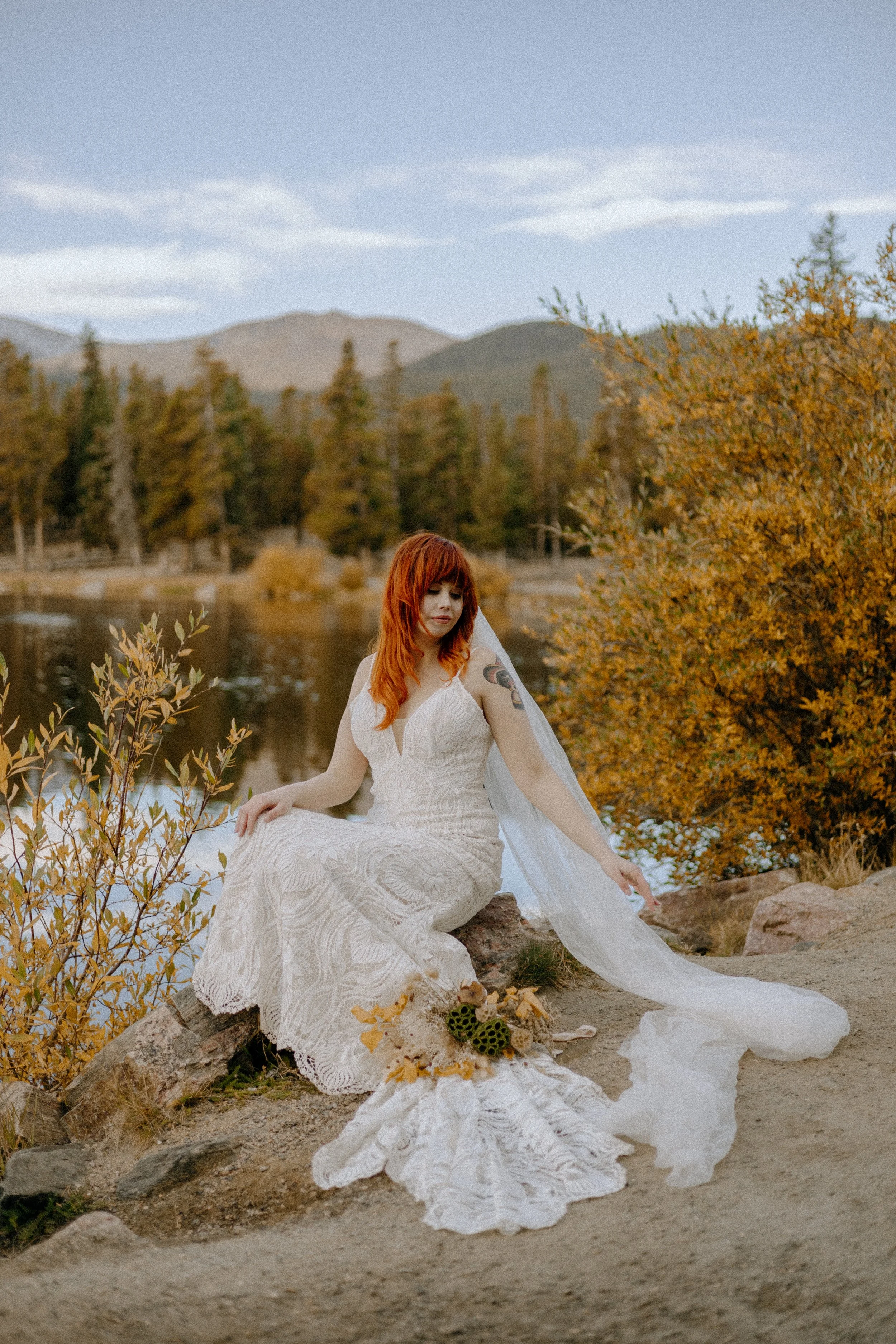 Houston & Texas Wedding & Elopement Photography – Bride sitting in wildflowers with golden trees at Echo Lake Colorado.