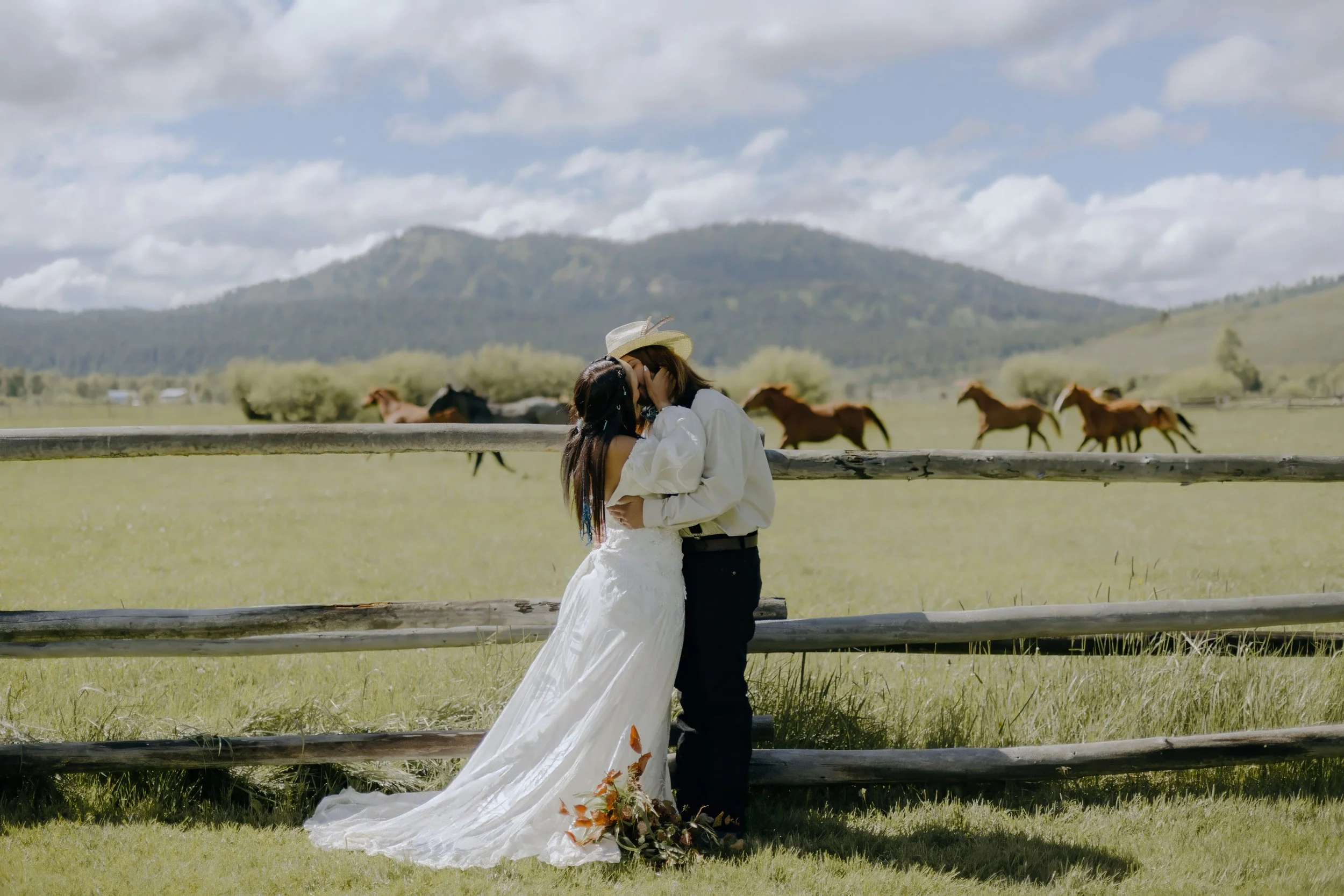 Houston & Texas Wedding & Elopement Photography – Couple strolling hand-in-hand past grazing horses at Diamond Cross Ranch.