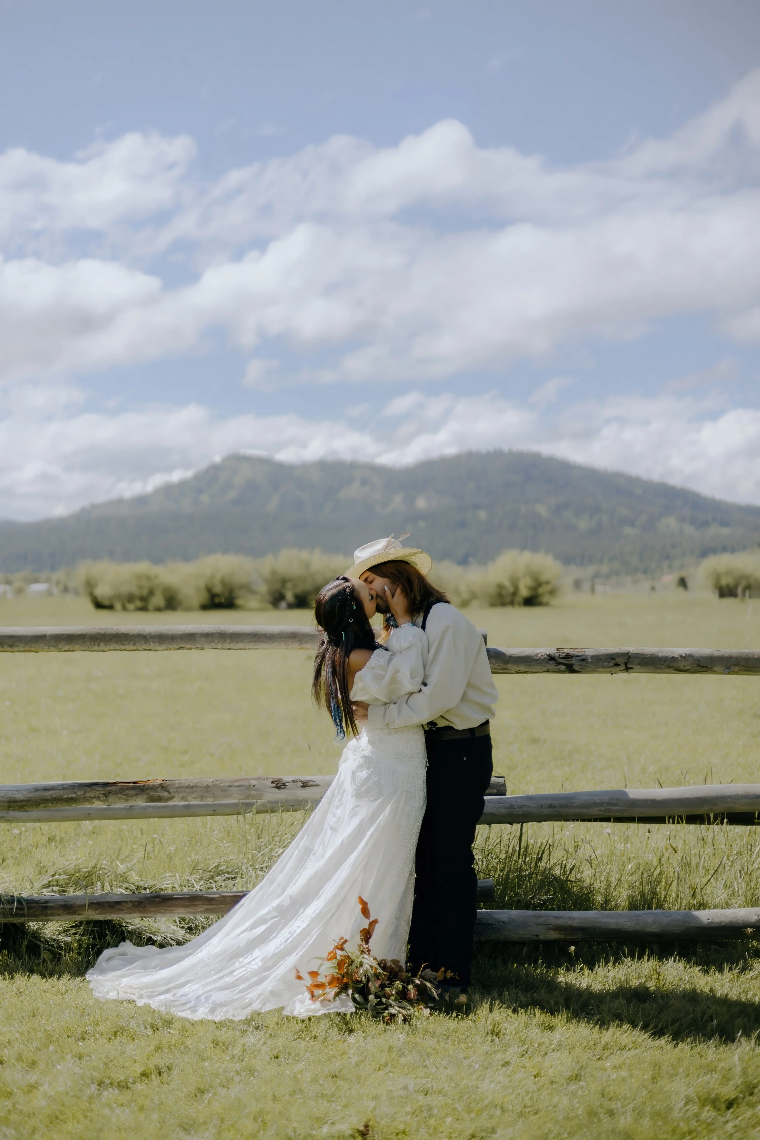 Houston & Texas Wedding & Elopement Photography – Bride and groom sharing kiss with Teton backdrop at Diamond Cross Ranch.