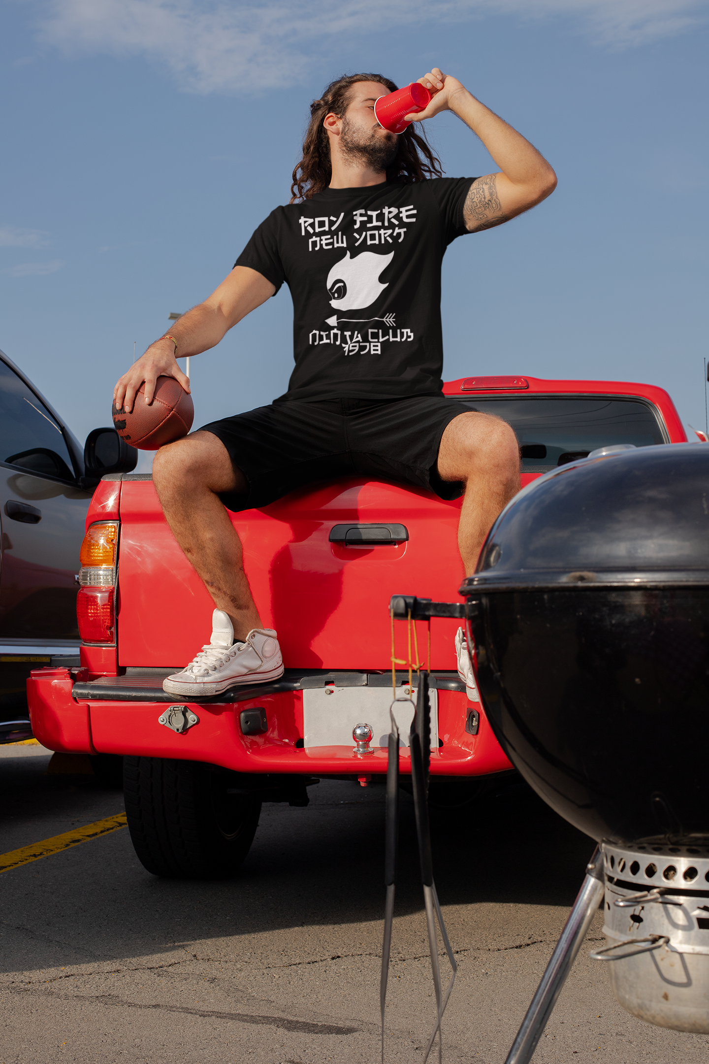 mockup-of-a-tattooed-man-with-a-crewneck-t-shirt-at-a-tailgate-party-29887.png