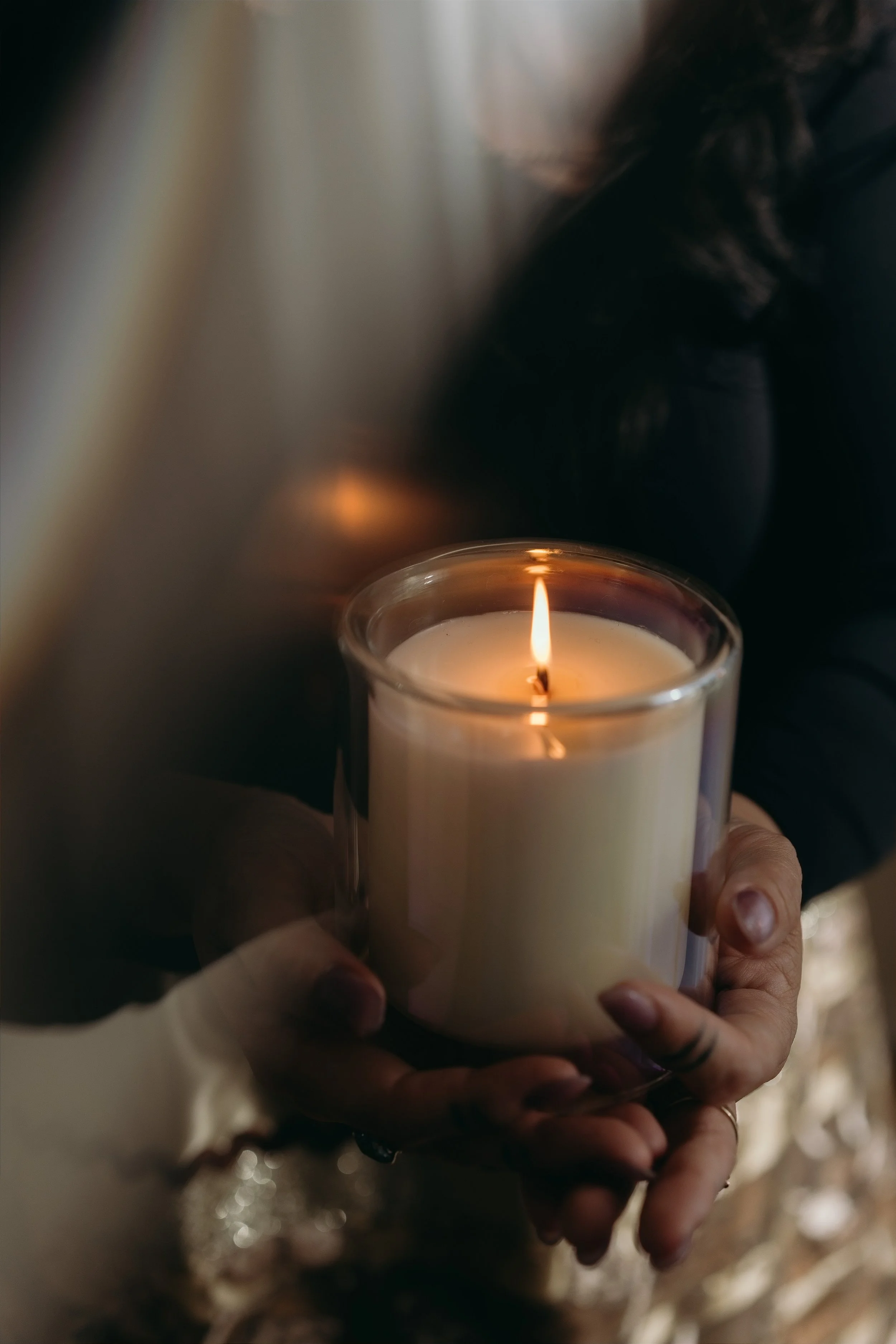 Medium Danielle Searancke holds a burning candle in her hands