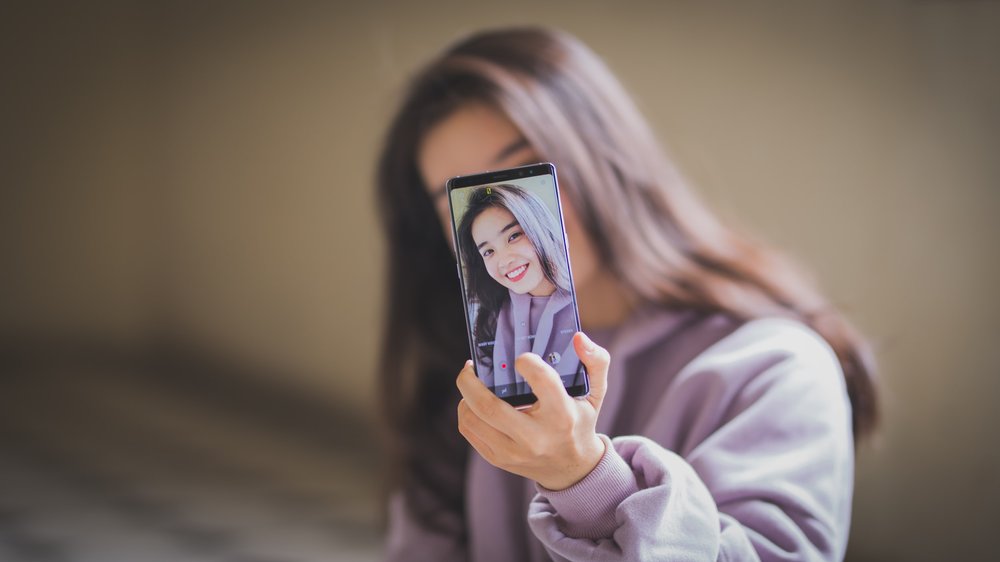 Smiling woman taking a selfie video.