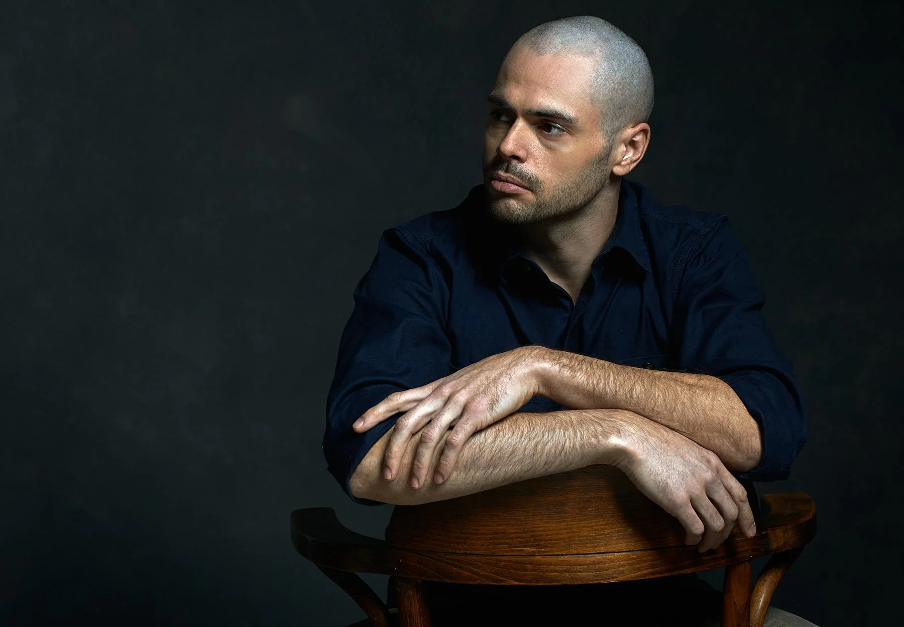 Portrait of collectible design artist Adam Bentz in his Seattle studio, known for sculptural furniture, wall sculpture, and illuminated design works.