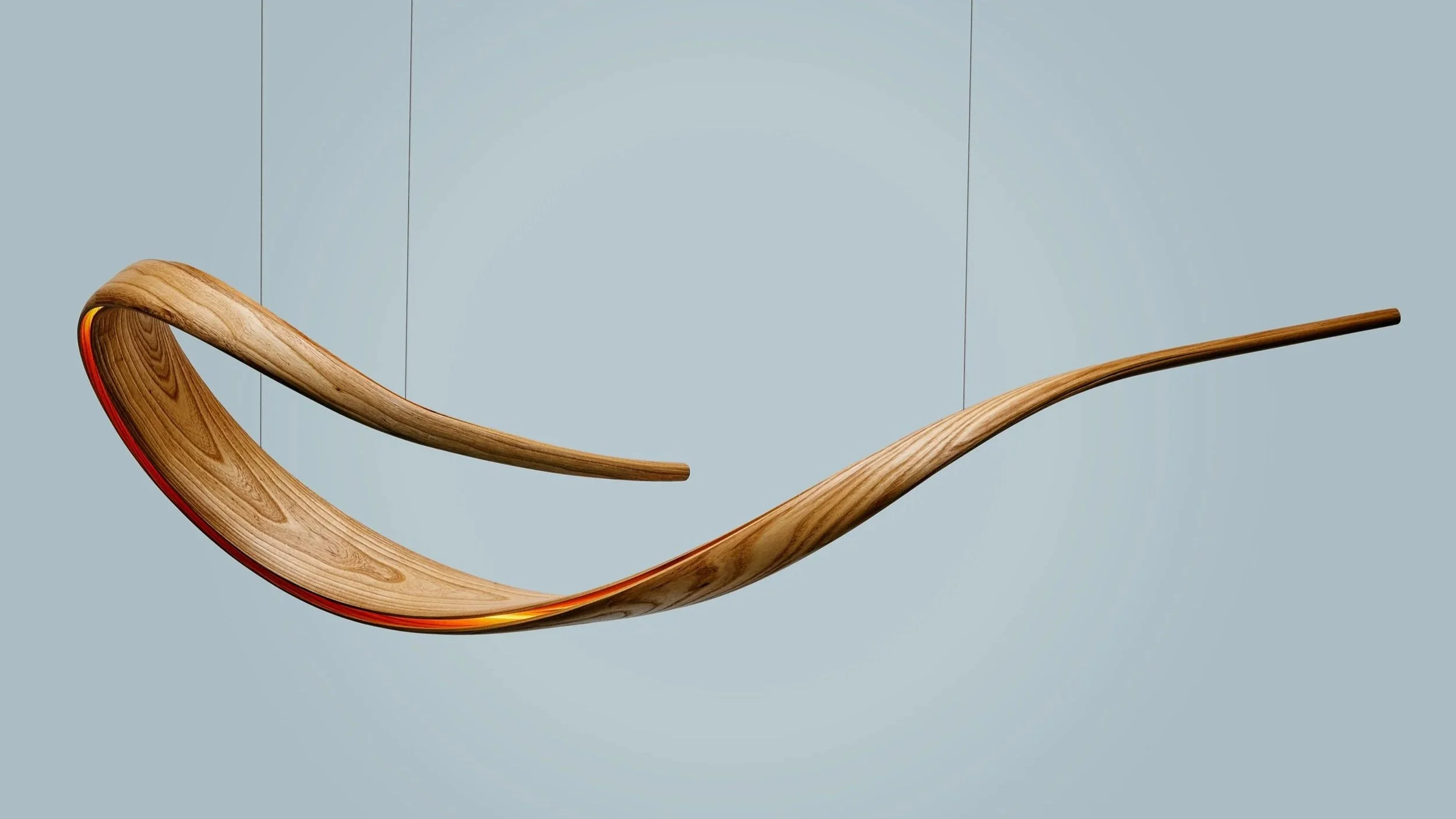 Suspended bent wood sculptural lighting with flowing illuminated organic form.