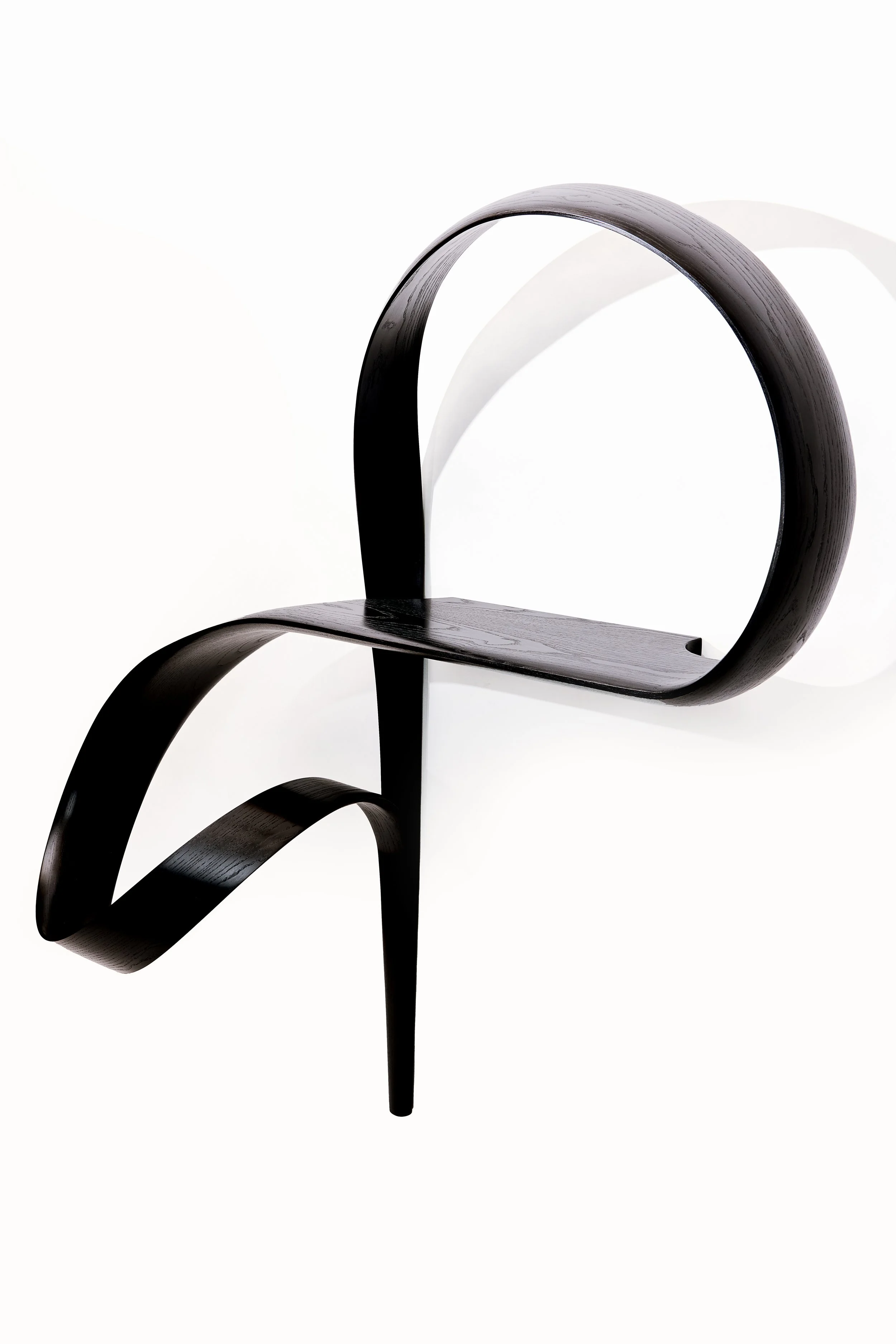 “Emovere bent wood wall sculpture by Adam Bentz featuring looping ribbon forms and a minimalist architectural composition.”