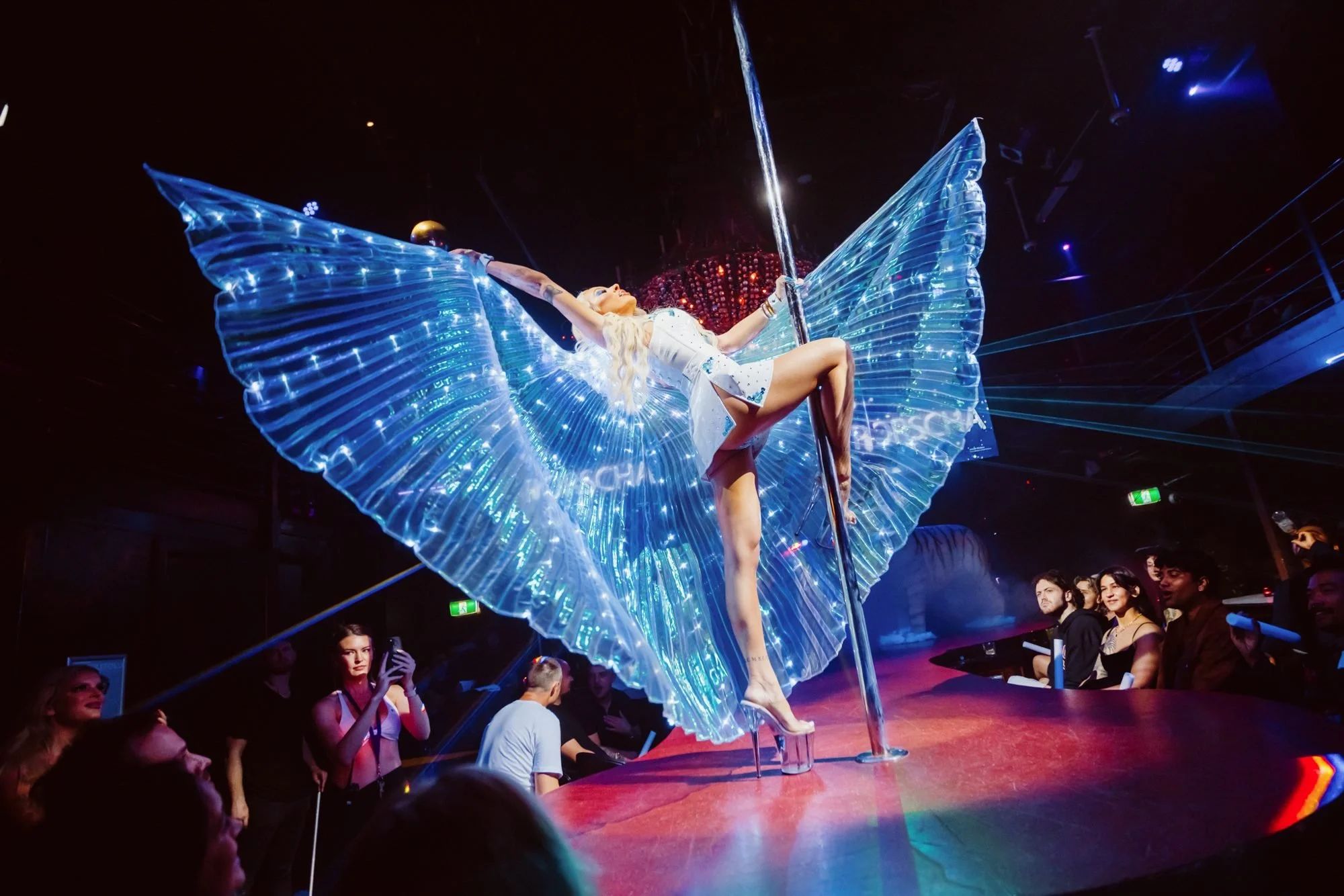 Porscha performing with illuminated wings on the Centrefold Lounge stage