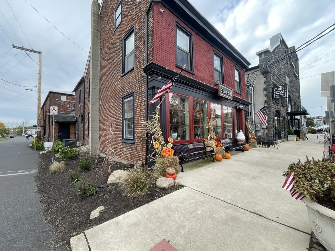 The ALLEVIATE studio building on East Broad Street beside the Trolley Barn Public Market, with the side street that leads to the entrance