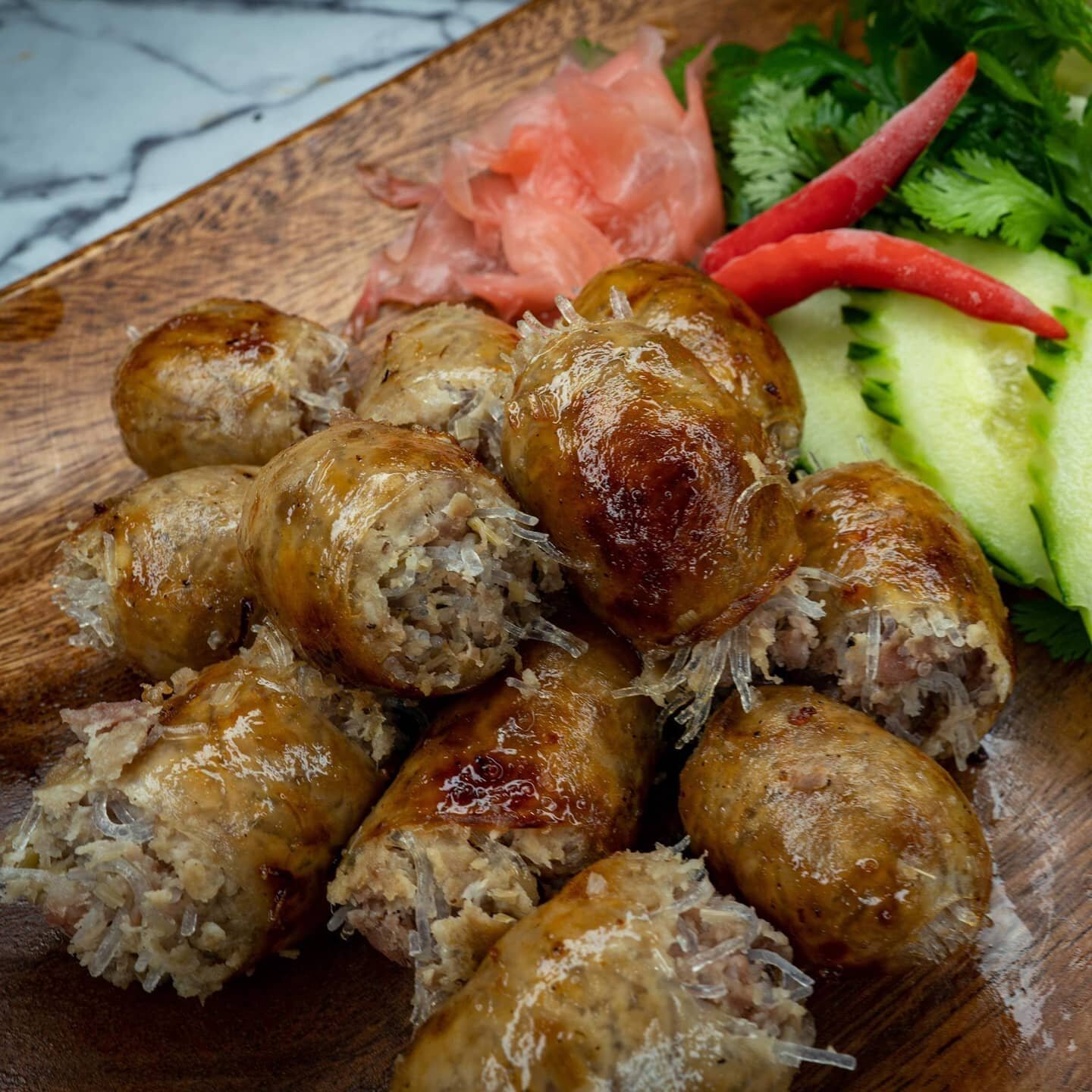 #Homemade Thai sausage grilled to perfection. The tasty inside made from glass noodles, rice, pork and special herbs. Served with vegetables and your choice of sticky or steamed rice #nofilter #thai #food #delicious #firethaifusion