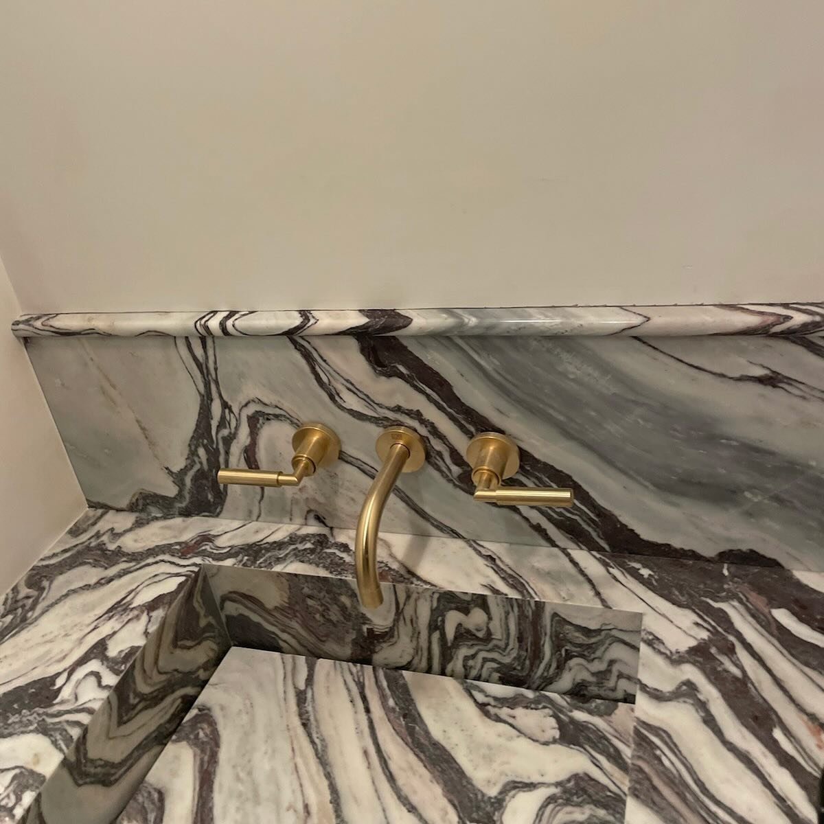 When you look at a zillion slabs for that perfect combination of color, movement and scale for the smallest space in the house- the powder room and Voila! A truly fantastic piece of Cipollino Fantastico appears. 
The cherry on top: the pencil rail tr
