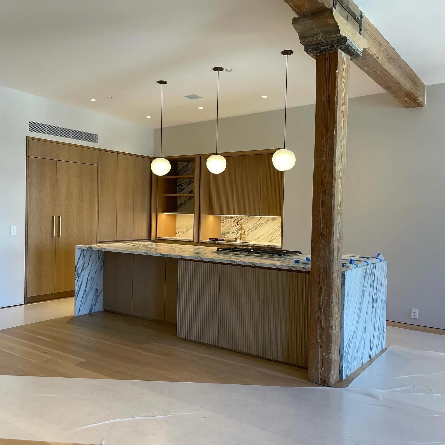 Sneak peek at the kitchen of our Tribeca loft project.  The cerused white oak  cabinets were inspired by the gorgeous exposed columns and beams in the space that had been stripped down to its natural color leaving bits and scapes of its painted histo