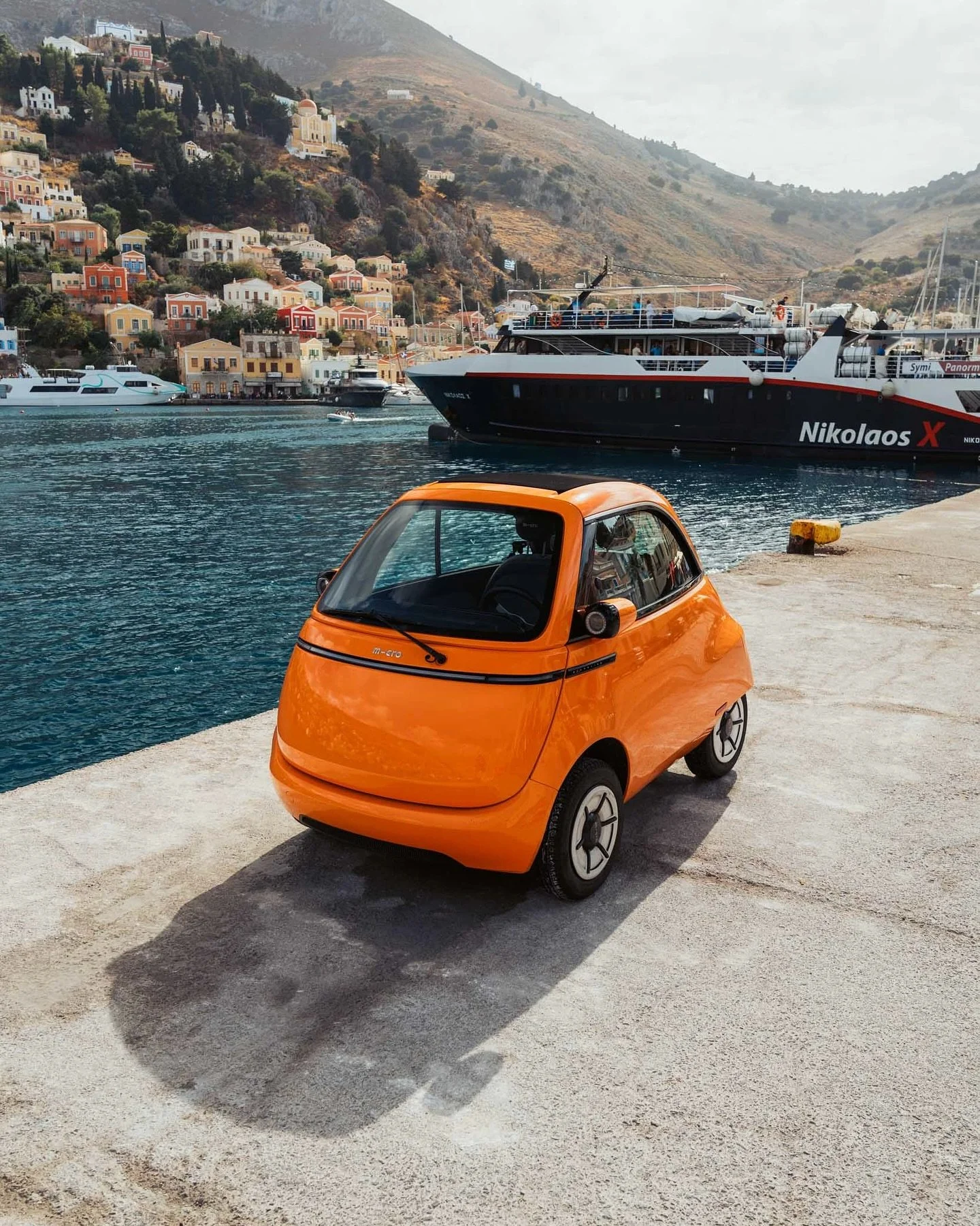 @microlino_official bringing some extra colour to the beautiful island of Symi, Greece. 

This car was a proper show stopper with people (myself included) stopping to snap photos of it, get a selfie with it (not me), or just have a nosey around it. 
