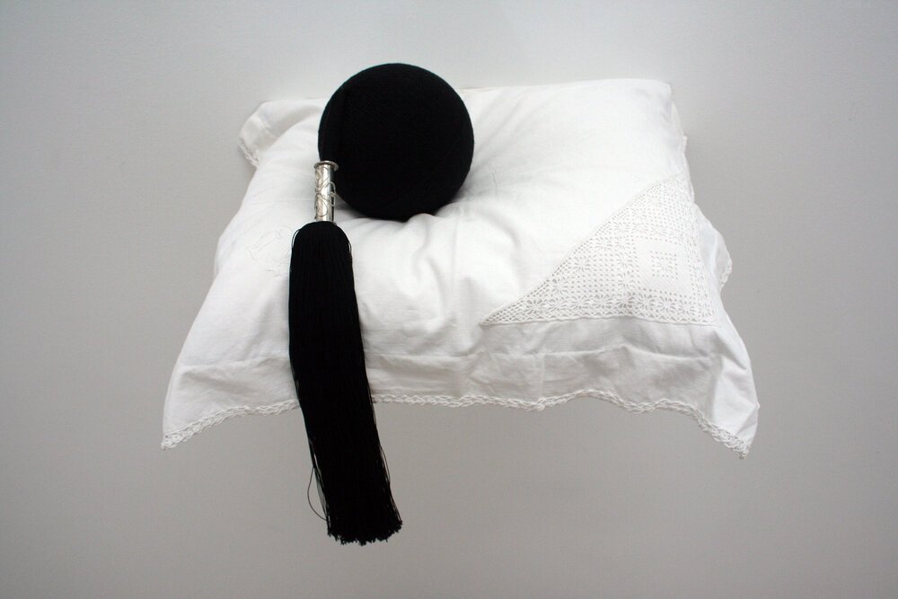 Skotthúfubomba (Bombshell) - knitted sculpture, wool, silver and silk on found linen pillowcase. 2008. Private collection