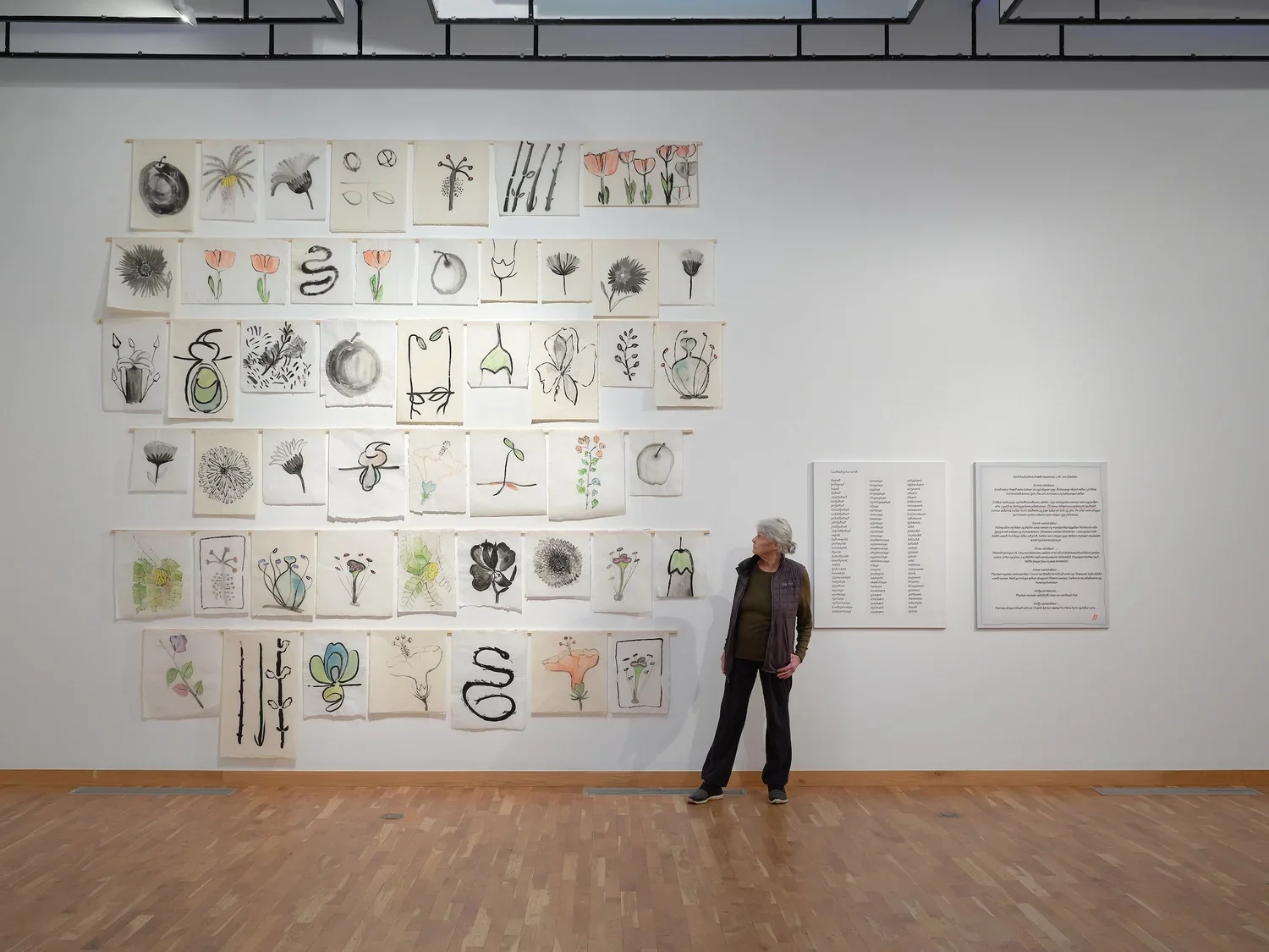 The artist Hildur Hákonardóttir with her work Conception with Nectar (2011) at the exhibition Red Thread 2023