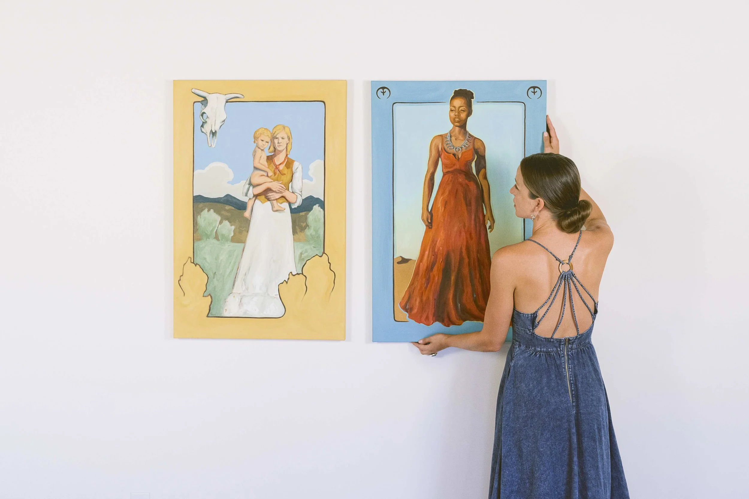 Photo of artist Gina Teichert wiht two of her paintings