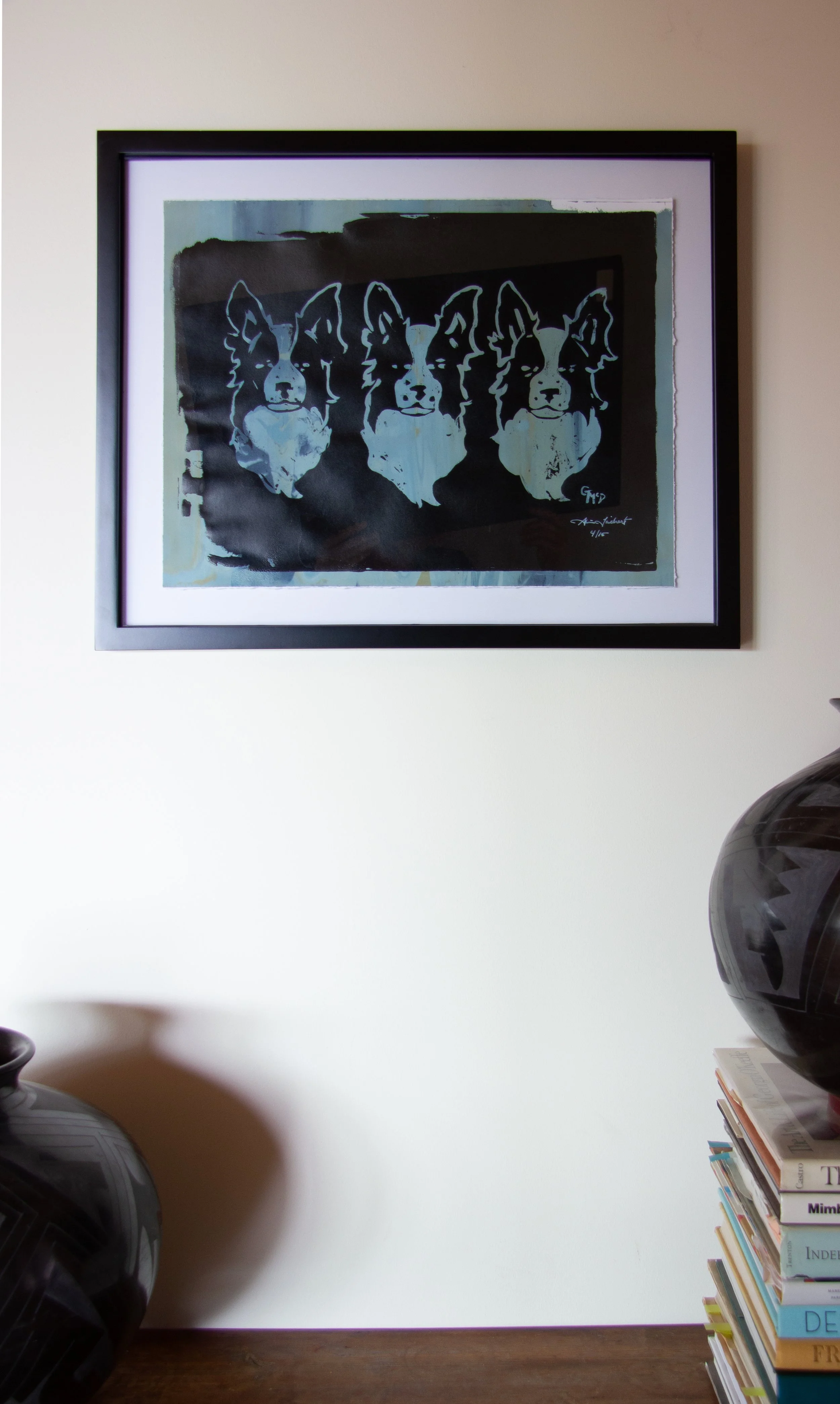 Screenprint of three border collie dogs on a green background