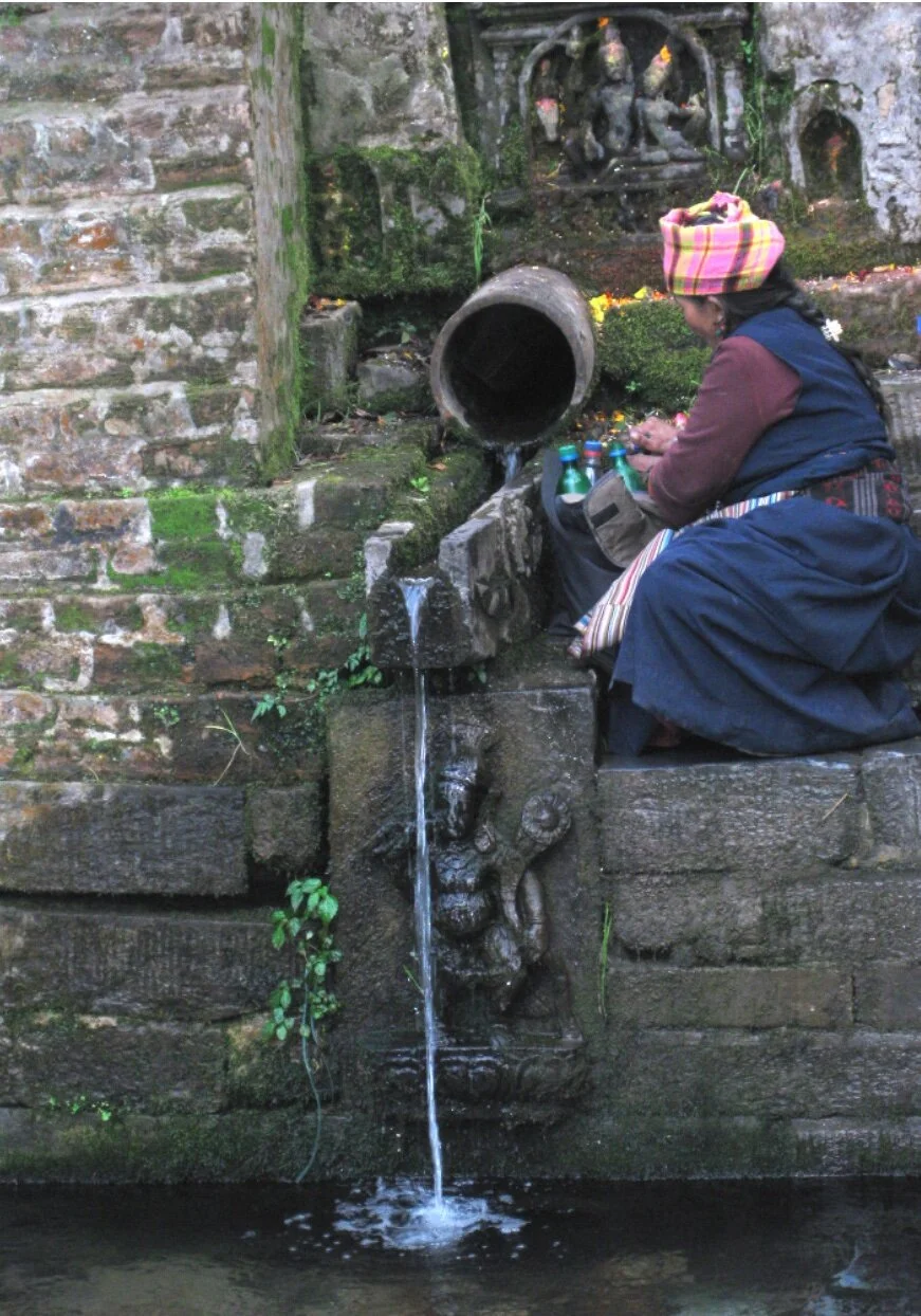 Tibetan Woman bottling blessed water Yanglesho.jpg