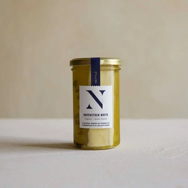 product shot of haverstock white plant-based cheese by nettle in a jar on white table