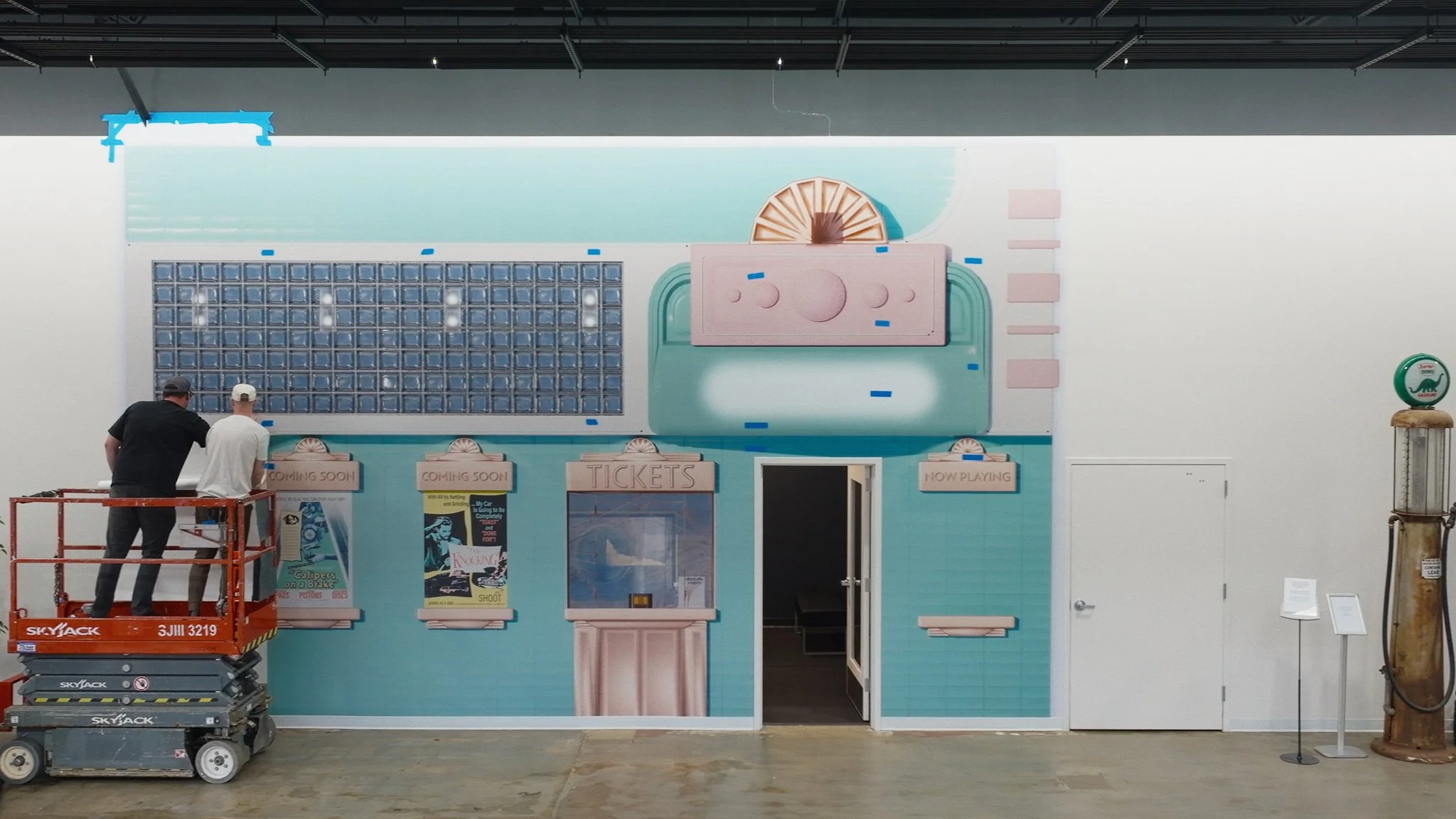 Custom vinyl installation transforming a wall into a fully designed storefront-style building facade