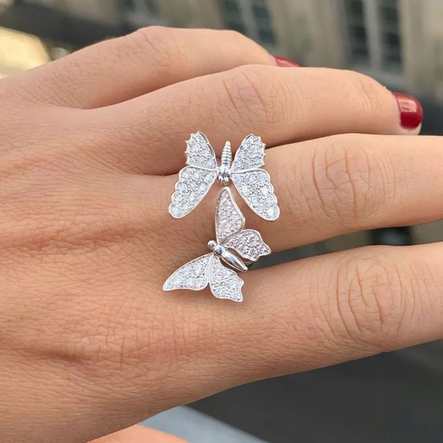Diamond butterfly ring on a woman's hand.