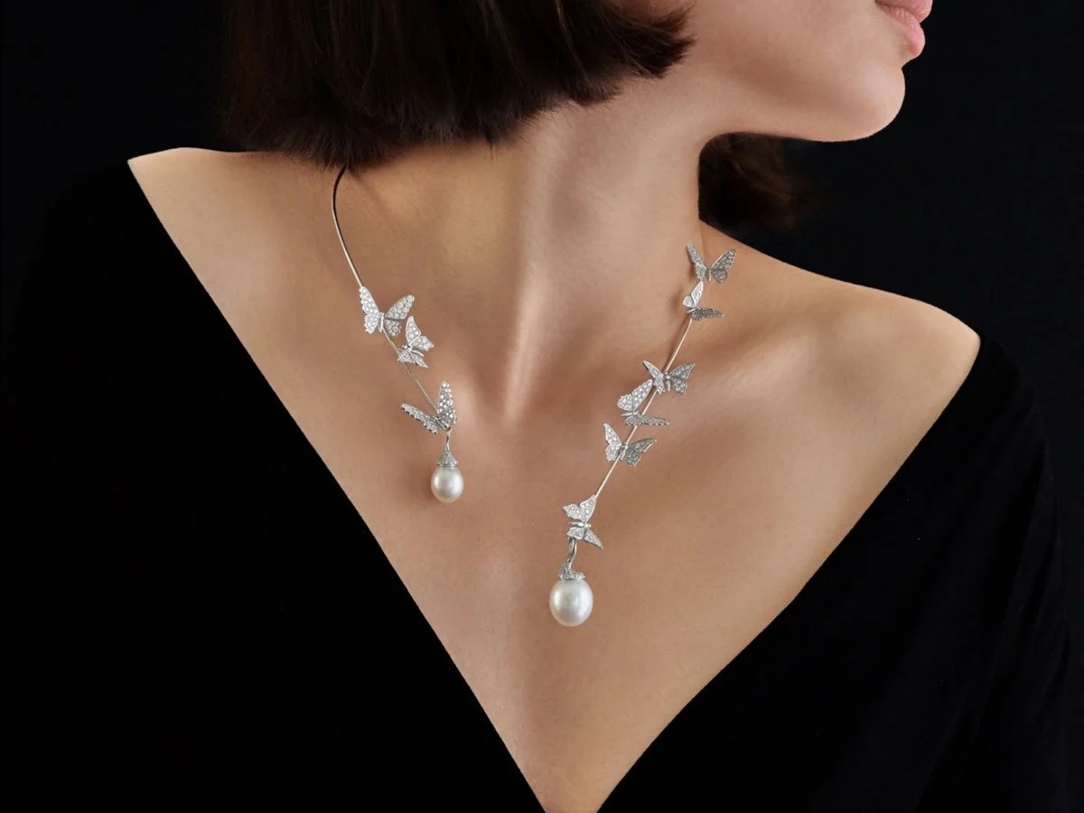 woman wearing butterfly diamond necklace with pearl drops