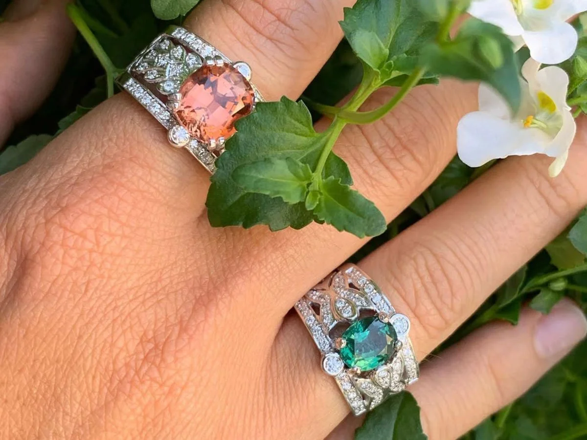 colored gemstone rings worn on a woman's hand