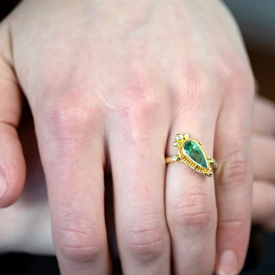 Emerald diamond ring in 22k gold on woman's hand