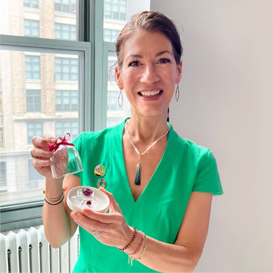 Fine Jewelry Concierge - Melissa holding investment quality ruby-hued gemstones