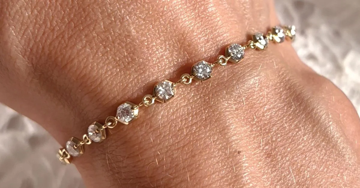 diamond-tennis-bracelet-worn-on-womans-wrist.jpg