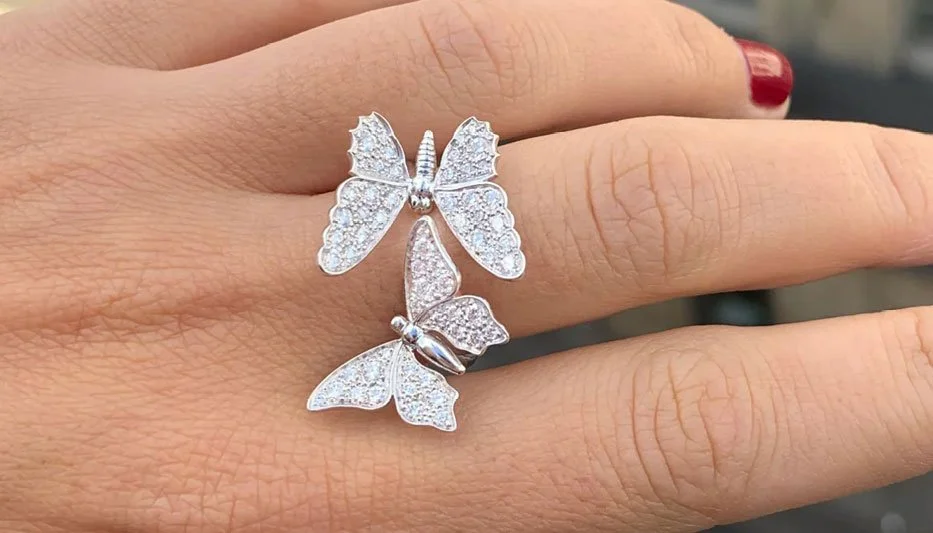 diamond butterfly ring worn on woman's finger