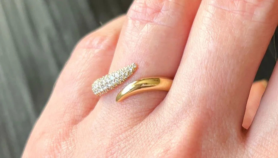 elephant ring on woman's finger with pave diamonds